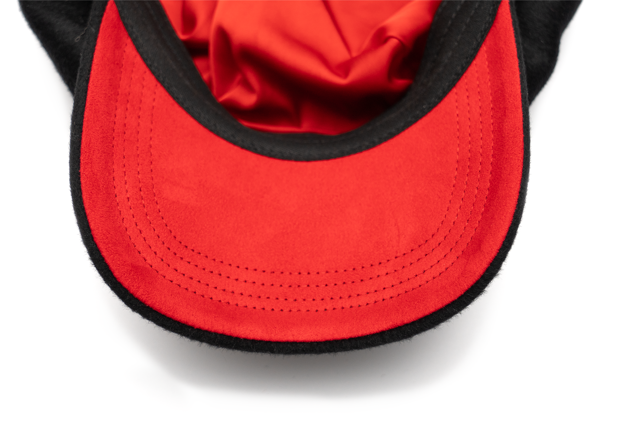 A black color cap with a visor, made of wool with satin lining and a logo pin on the front.