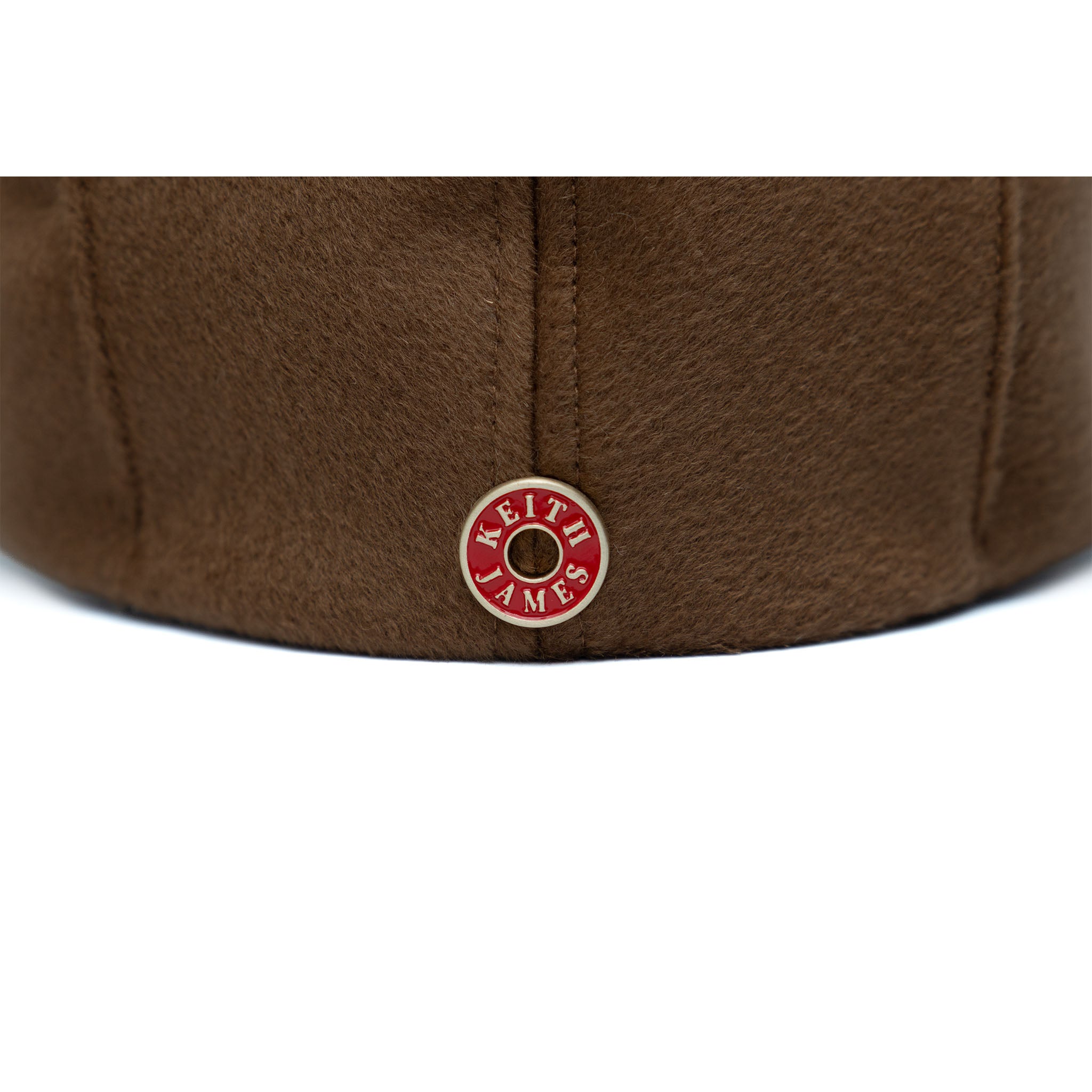 A brown newsboy cap made of wool with a cotton twill visor, featuring a branded logo on the front.