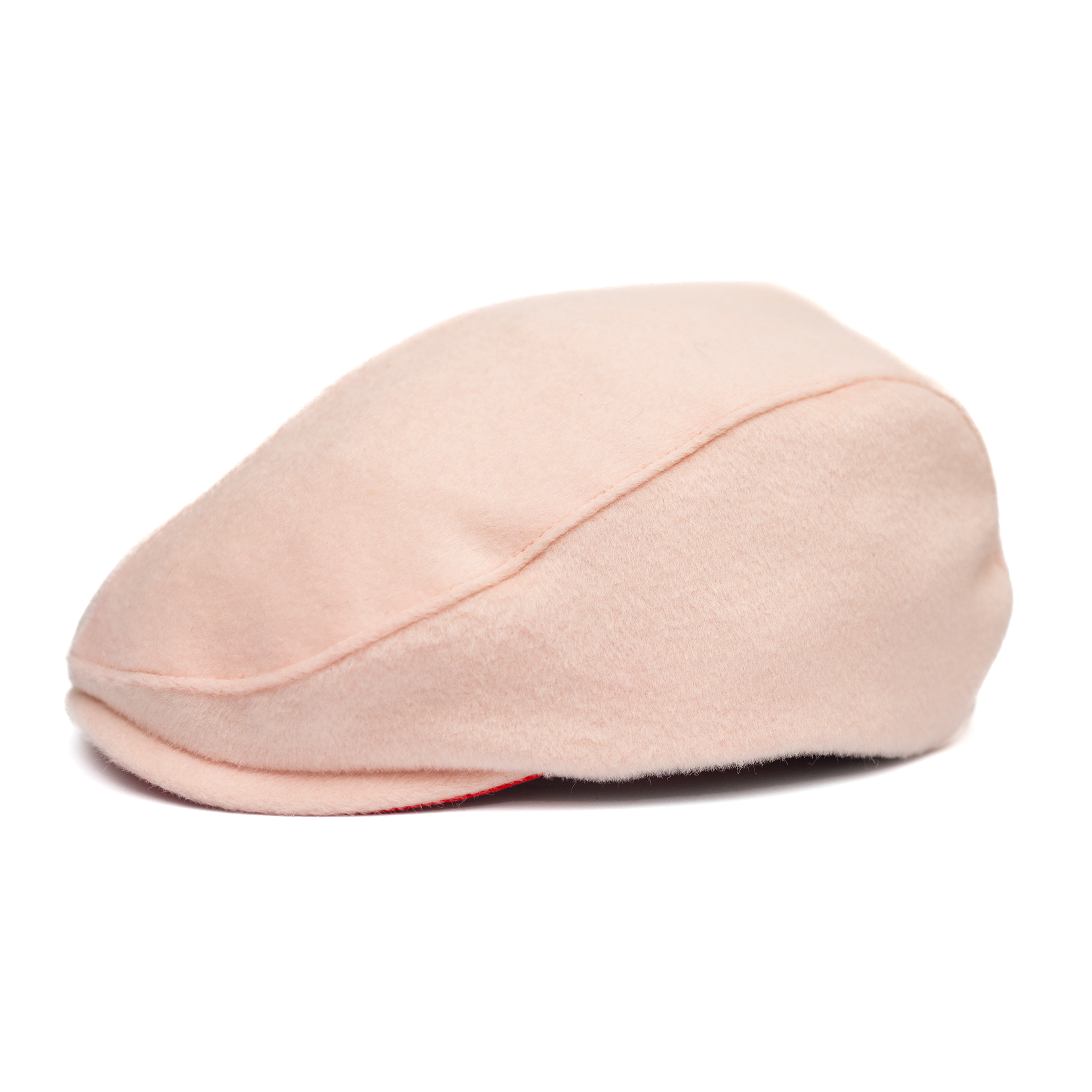 A soft pink newsboy cap with a flat visor, made of Australian wool, featuring a satin lining and gold hardware.