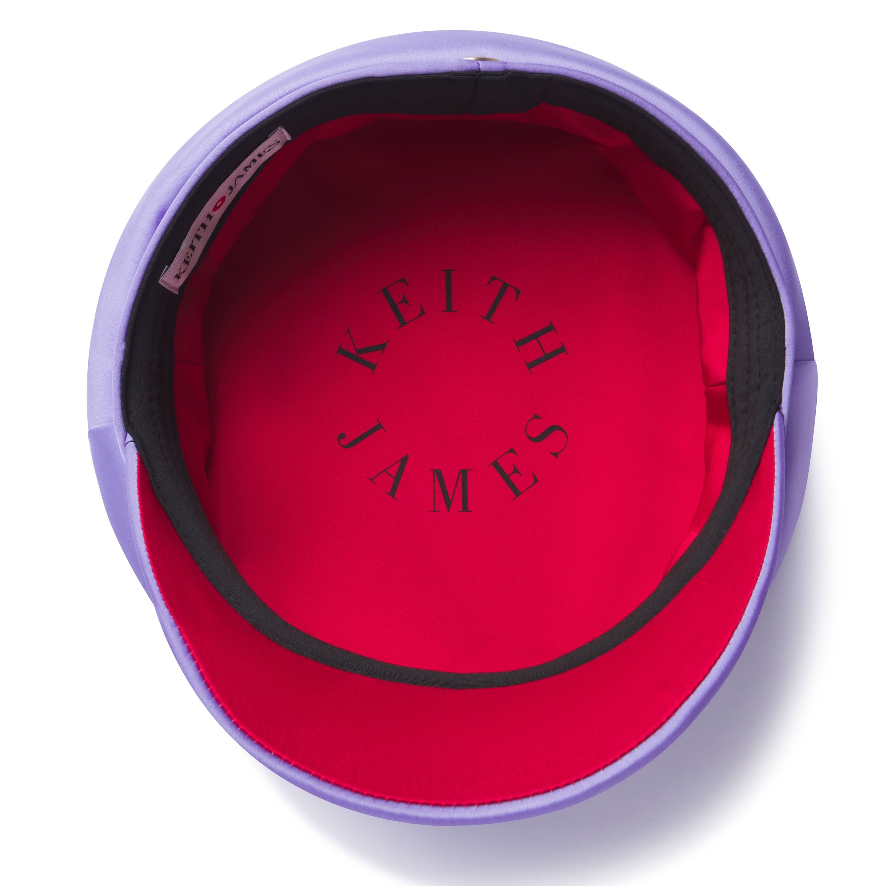 Red interior of a product with 'Keith James' branding, surrounded by purple material.
