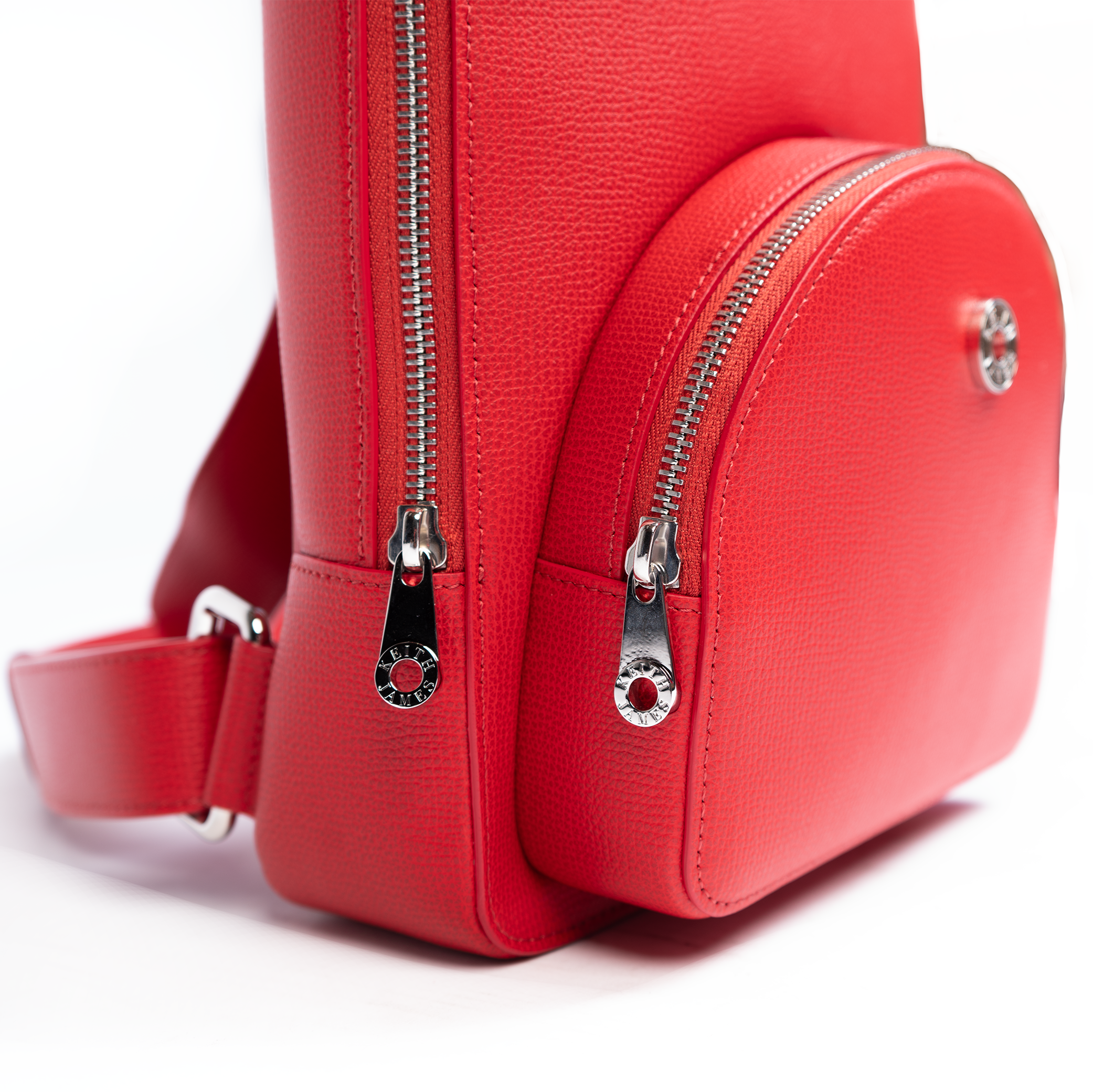 A rose red backpack with a front zipper pocket and adjustable straps on a white background.