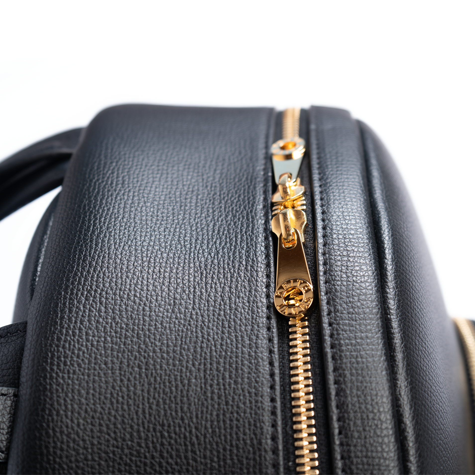 A jet black leather backpack with gold-tone hardware, featuring multiple compartments and a front zipper pocket.
