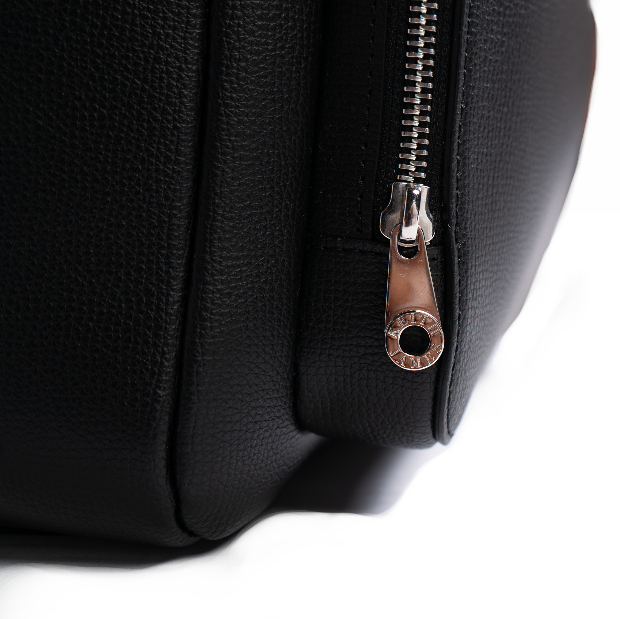 A jet black leather backpack with gold-tone hardware, featuring multiple compartments and a front zipper pocket.