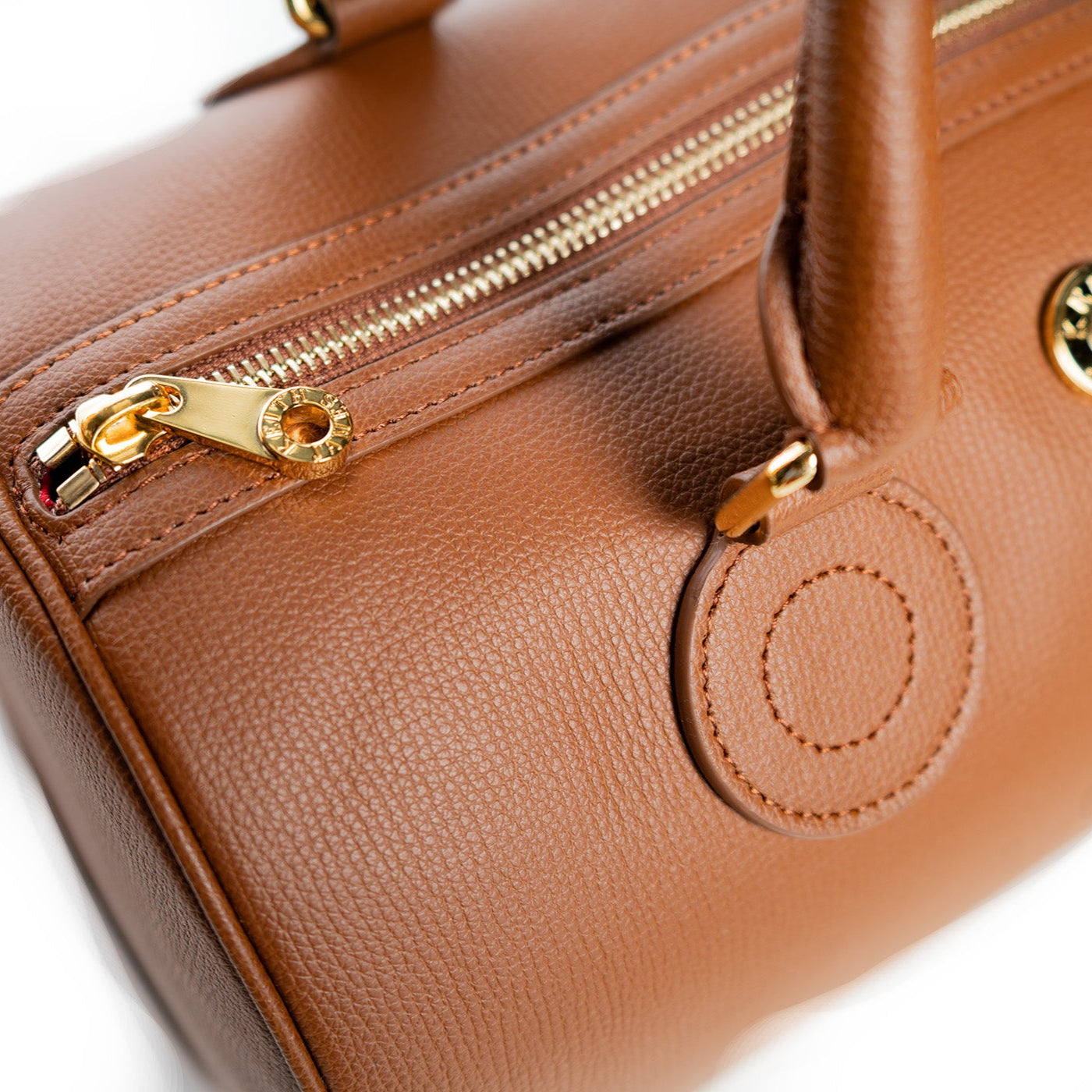 A cocoa brown handbag with a structured shape and gold-tone hardware.