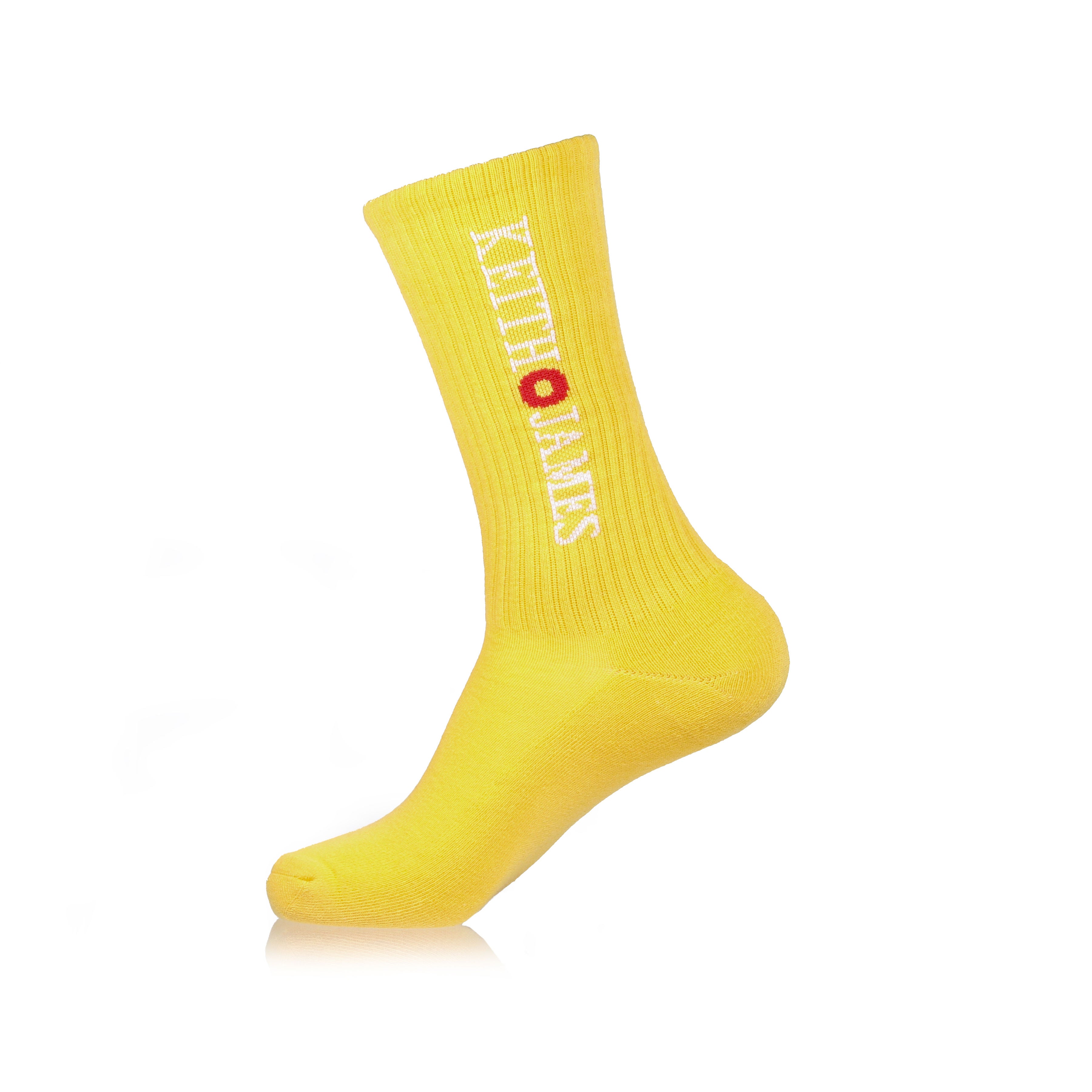 A single yellow sock with text pattern, displayed in a standing position.