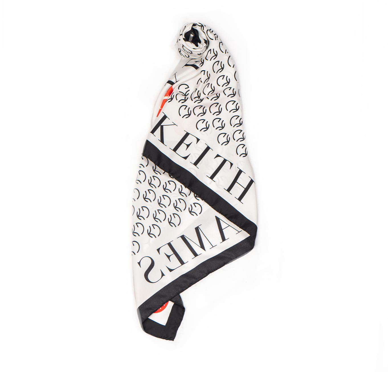 A silk scarf with a geometric pattern featuring the text 'KEITH' and the logo 'G', predominantly in black, white, and red colors.