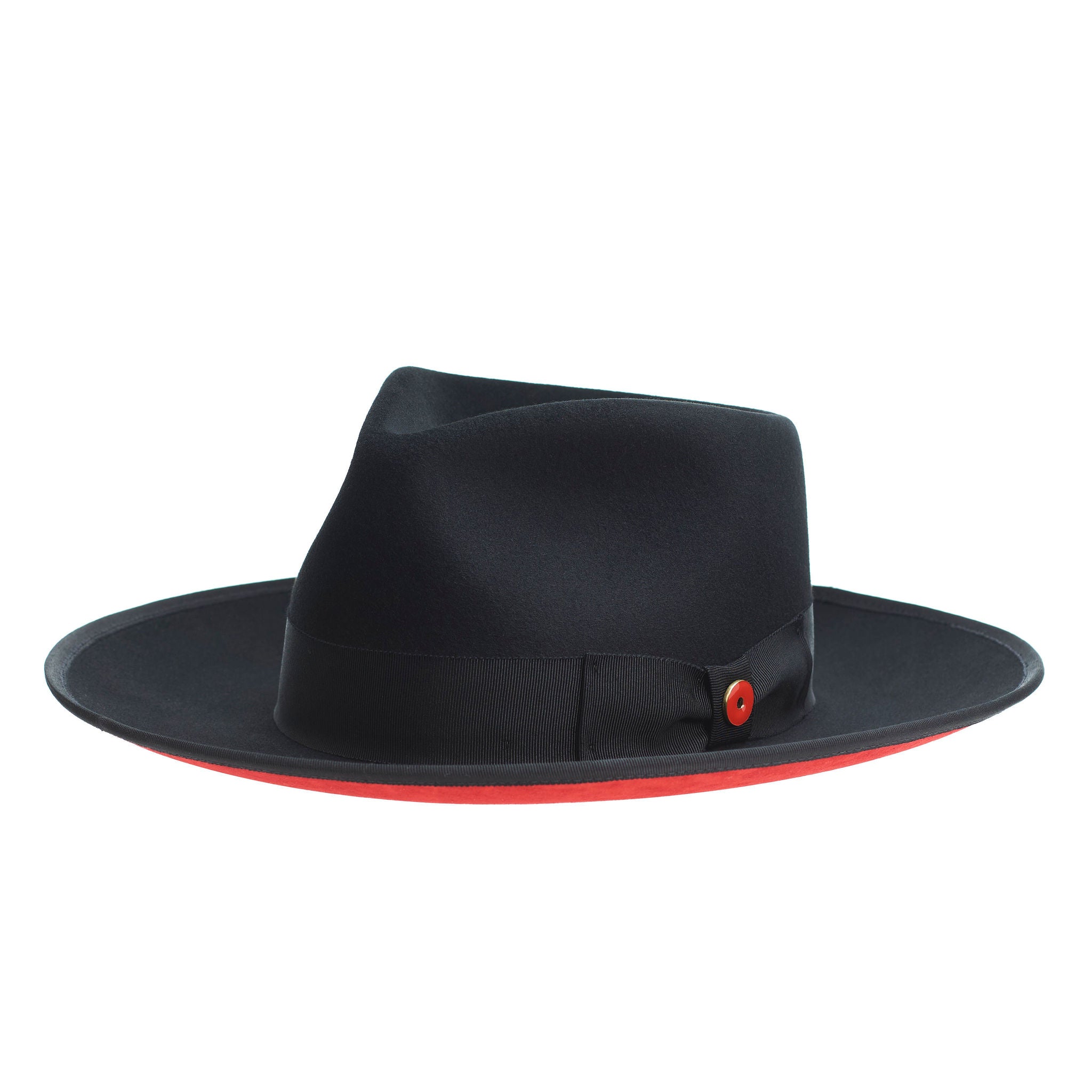 A classic black hat with a red bottom brim and a signature logo pin on the side.