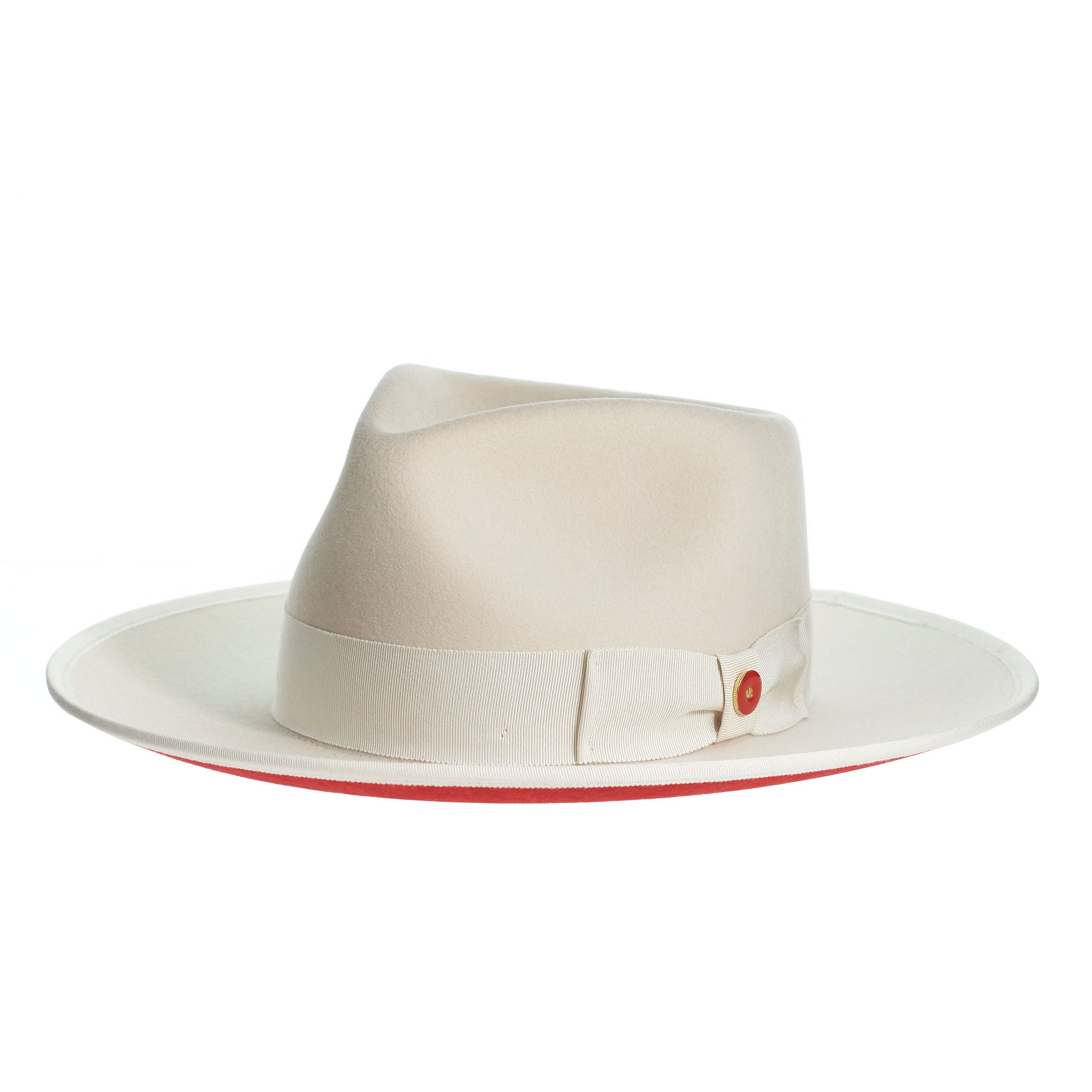 A sandy beige hat with a red bottom brim, a classic wide ribbon, and a bow signature logo pin.