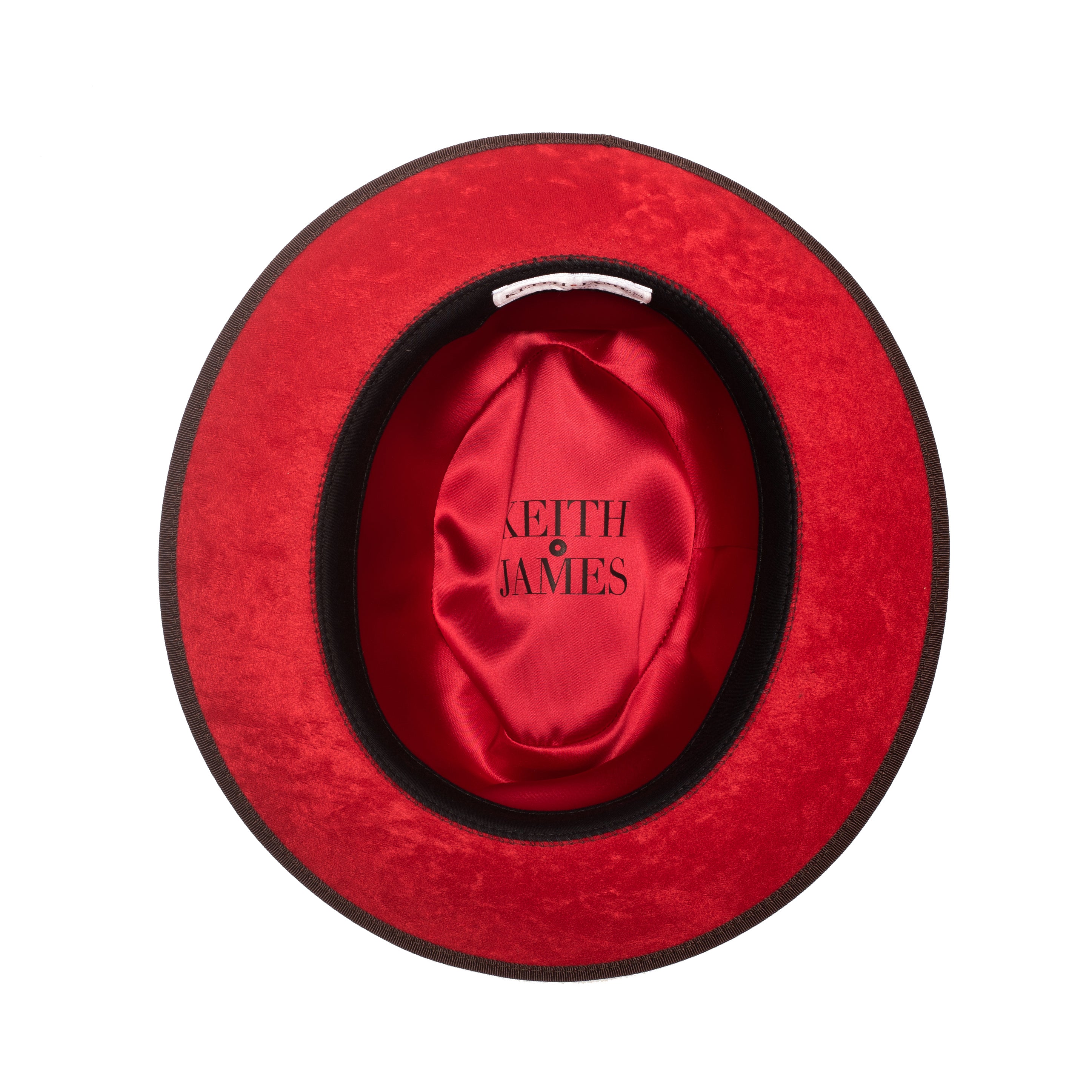 A cocoa brown classic center-creased fedora with a 2.5 inch curved brim and bound edge, featuring a red bottom brim and a signature logo pin.