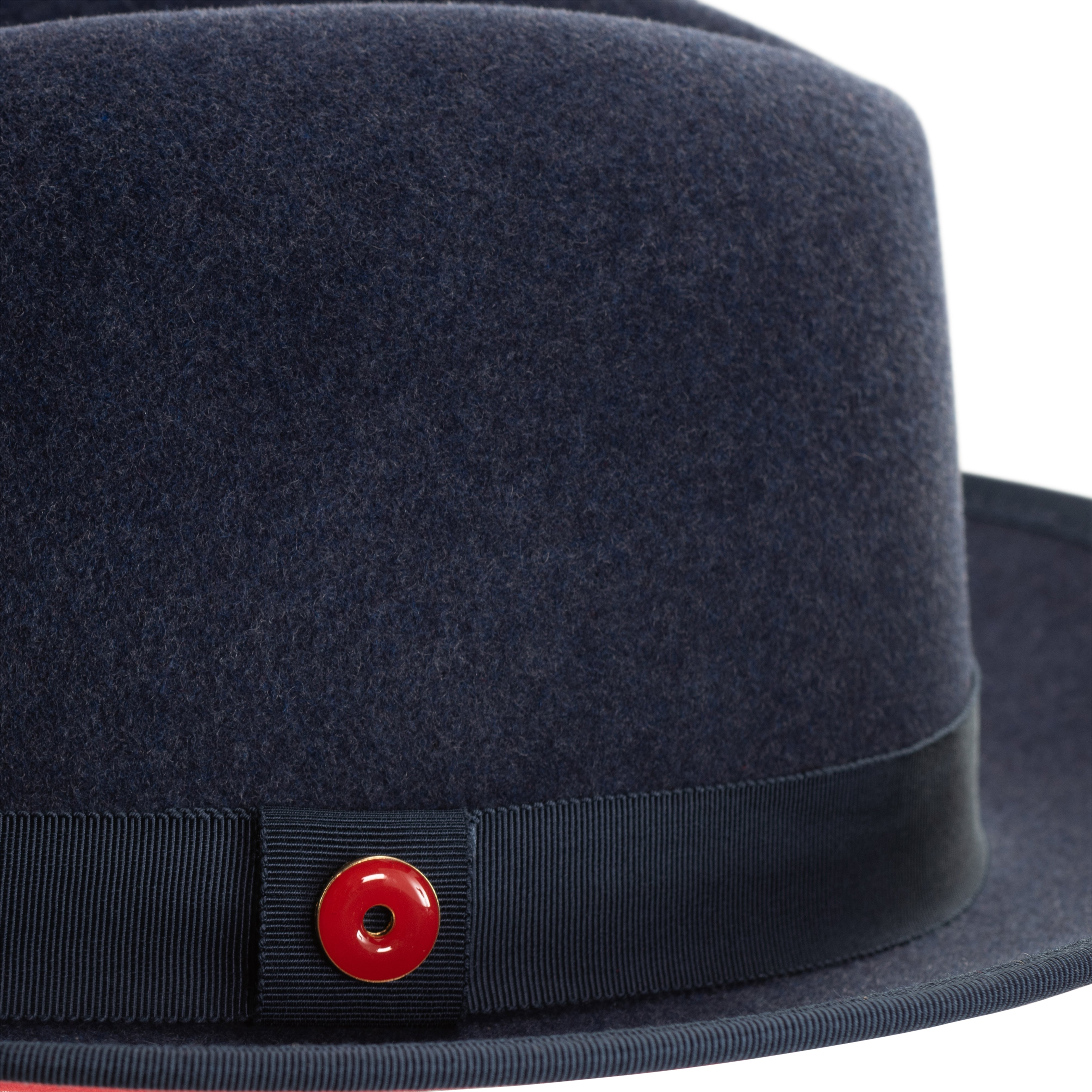 A denim blue classic center-creased fedora with a 2.5 inch curved brim and a red bottom trim, featuring a classic ribbon trim and a signature logo pin.