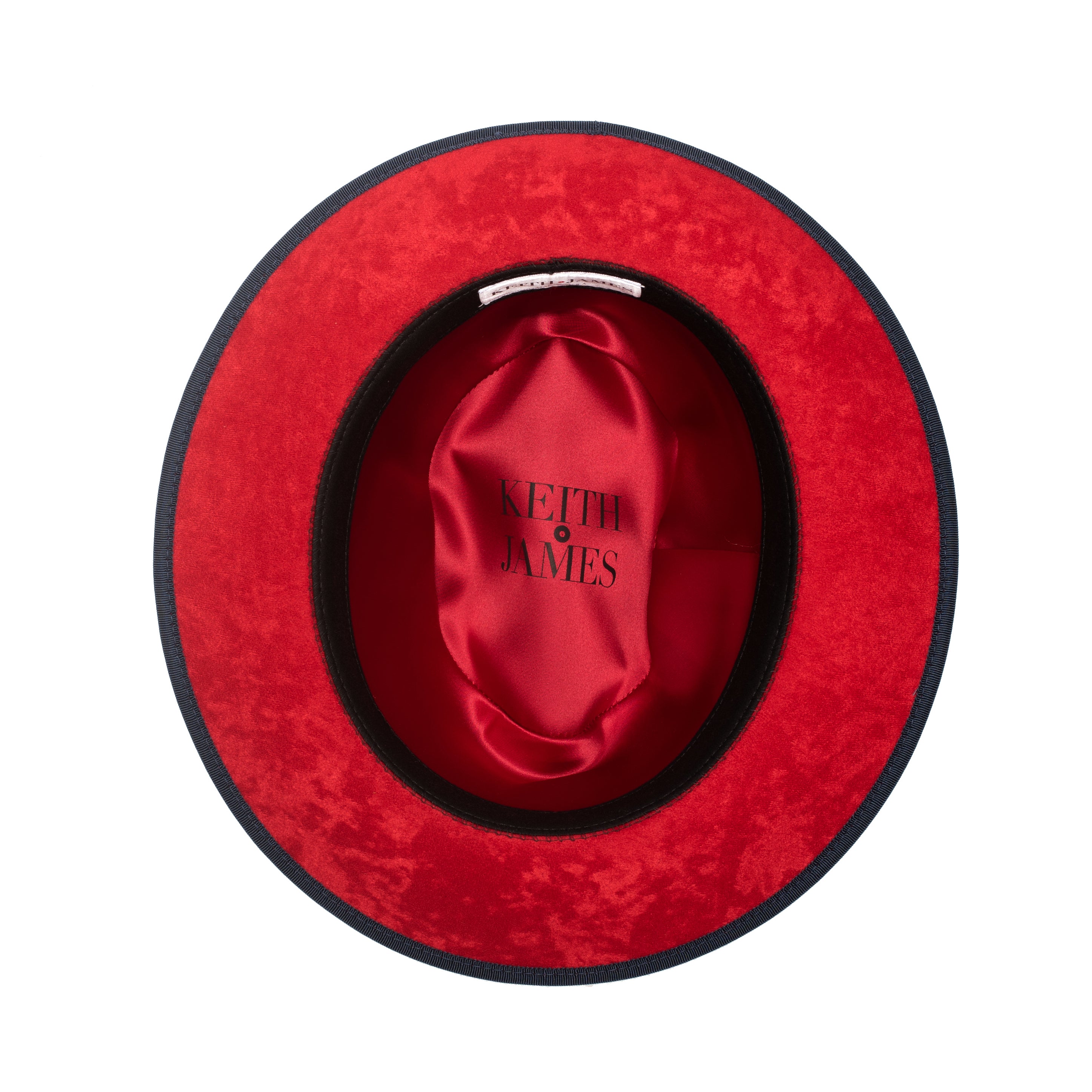 A denim blue classic center-creased fedora with a 2.5 inch curved brim and a red bottom trim, featuring a classic ribbon trim and a signature logo pin.