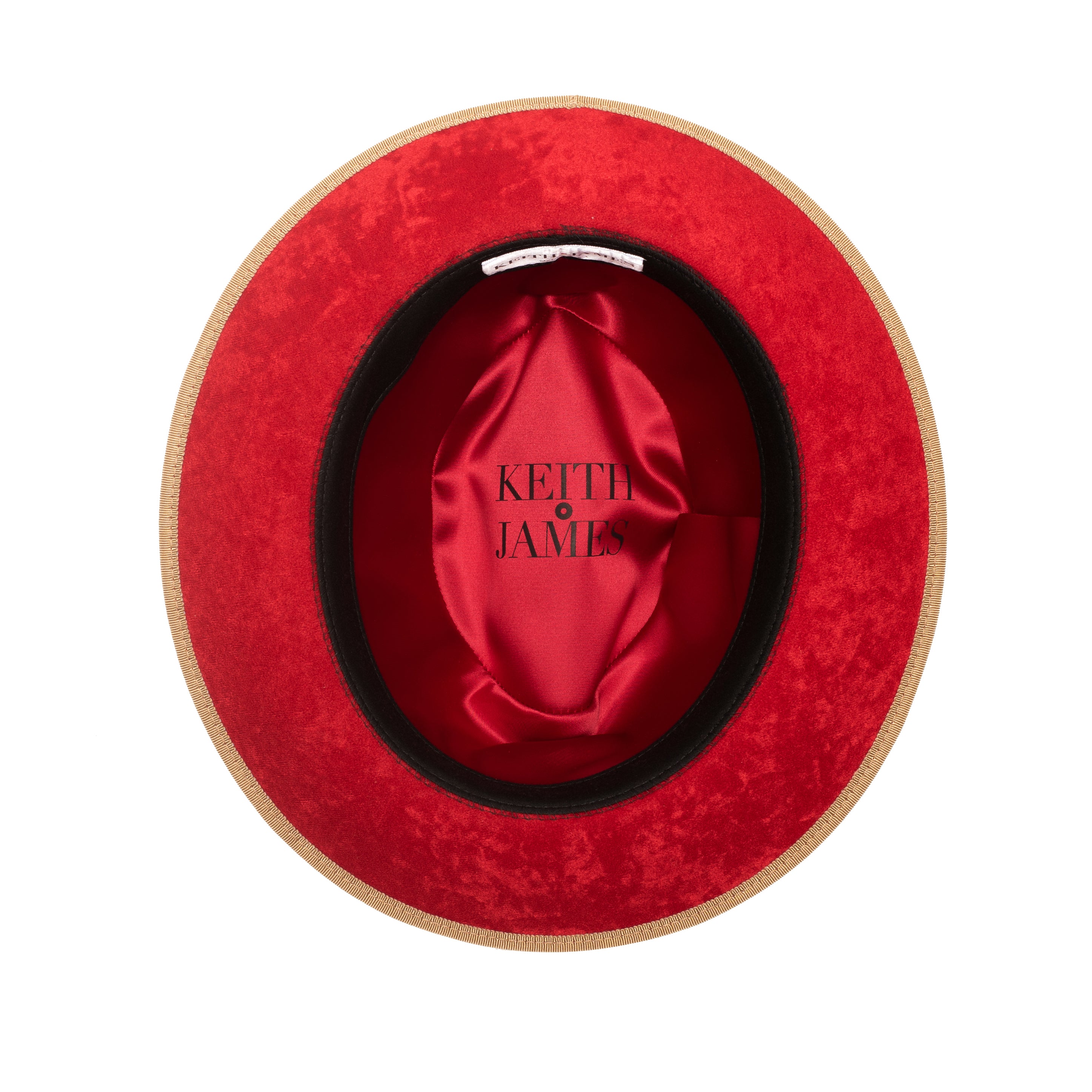 A golden honey colored fedora with a red ribbon trim and a red bottom brim, featuring a signature logo pin.