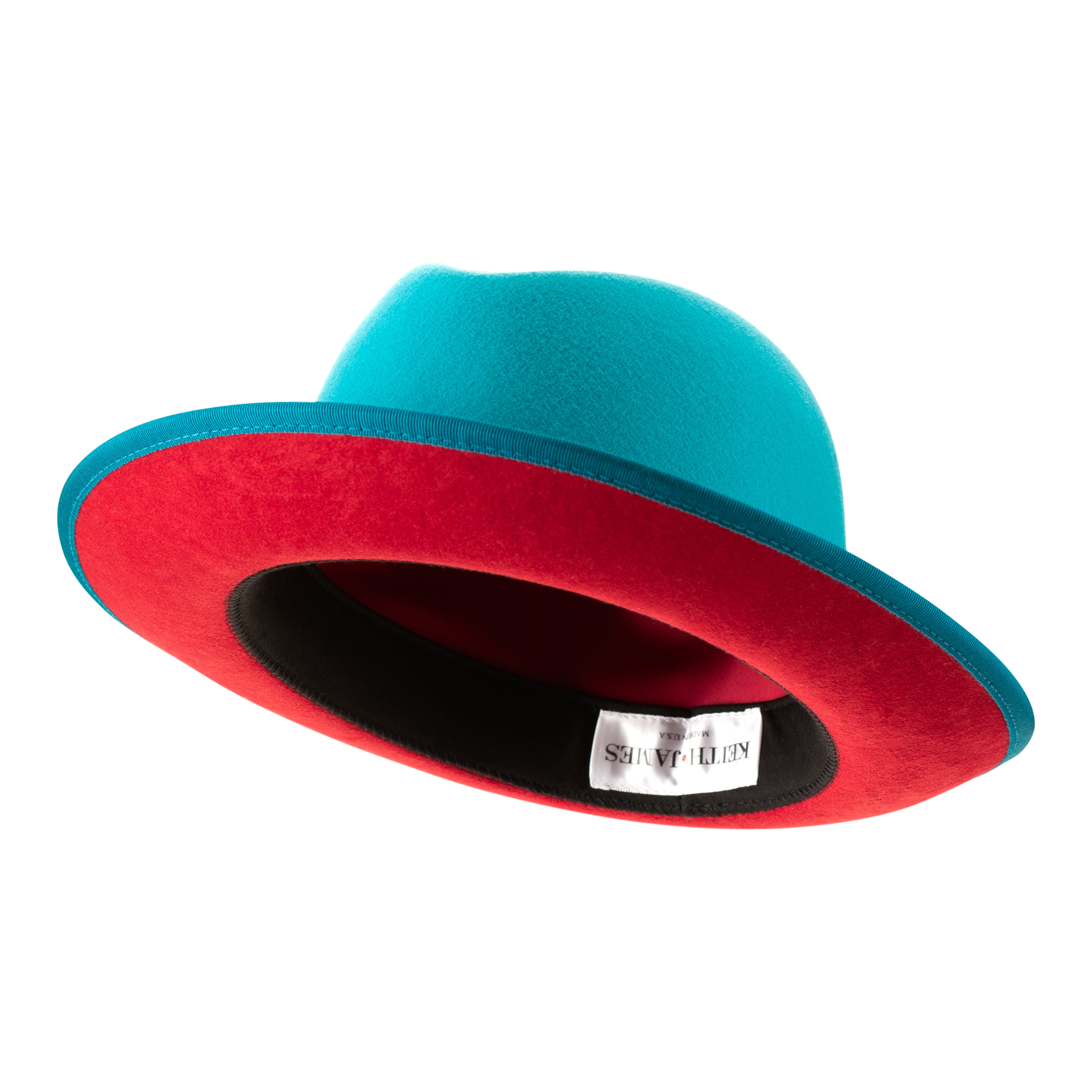 A classic center-creased fedora hat in ocean blue color with a red bottom brim and a signature logo pin.