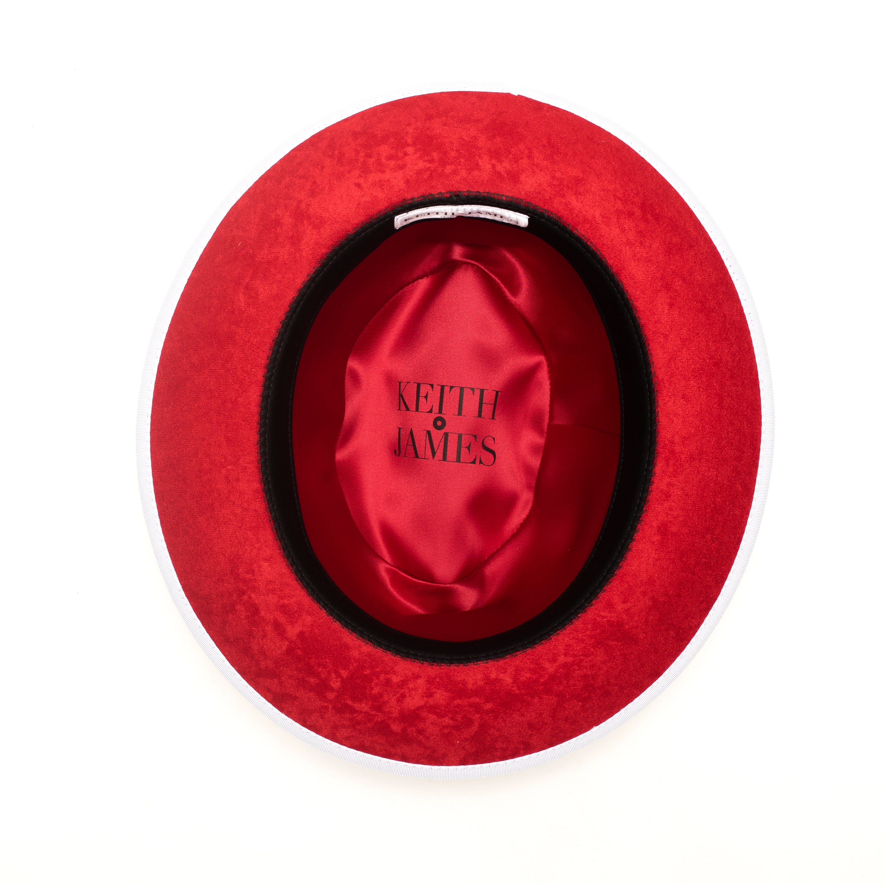 A snow white fedora hat with a red bottom brim and a signature logo pin.