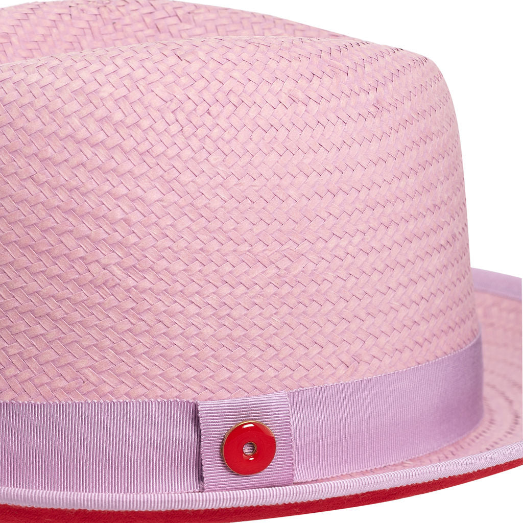 A purple classic center-creased fedora with a 2.5 inch curved brim, featuring a red bottom brim and a signature logo pin.