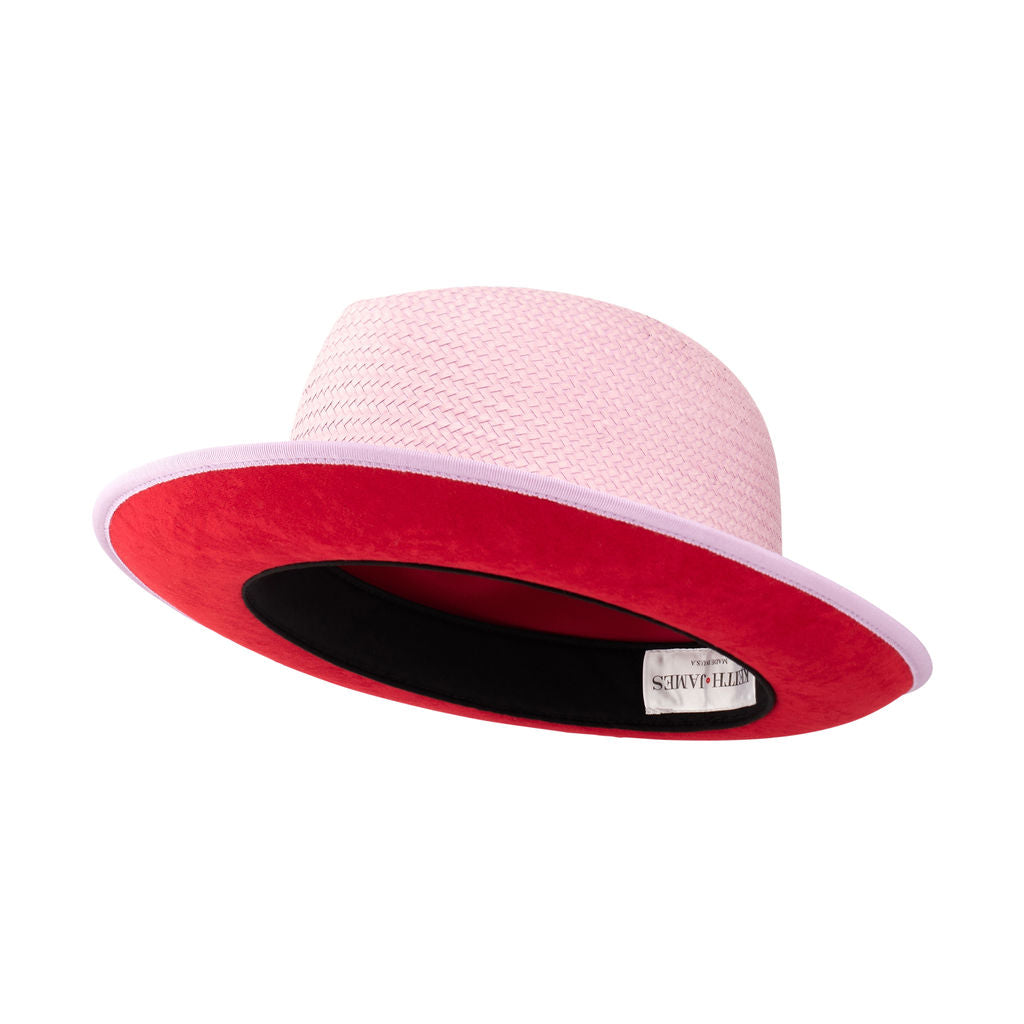 A purple classic center-creased fedora with a 2.5 inch curved brim, featuring a red bottom brim and a signature logo pin.