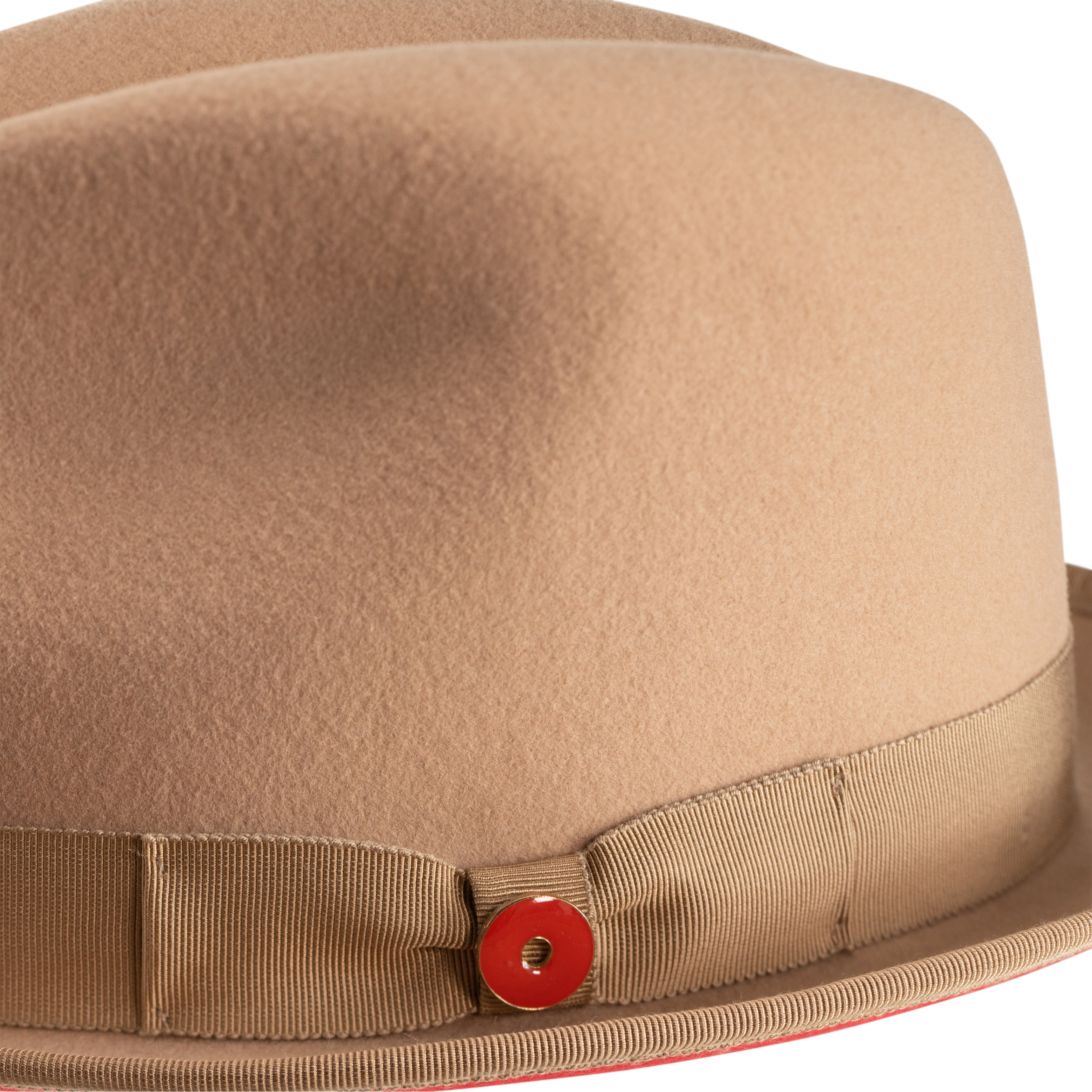 A golden honey colored fedora hat with a pinched crown, a 2-inch brim, and a red bottom brim. It includes a classic ribbon and bow with a signature logo pin.
