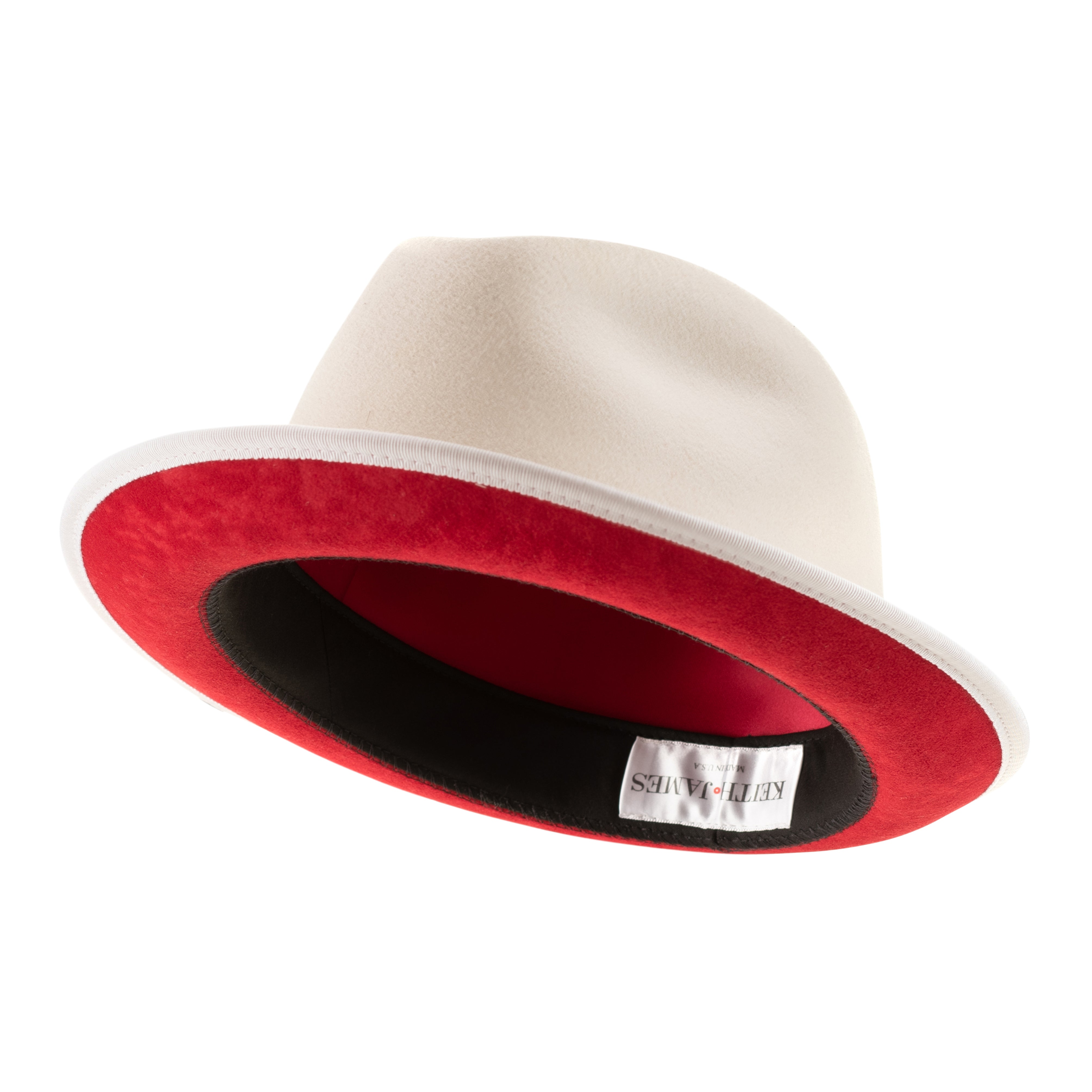 A snow white colored fedora hat with a white and red ribbon around the base and a red bottom brim, featuring a signature logo pin.