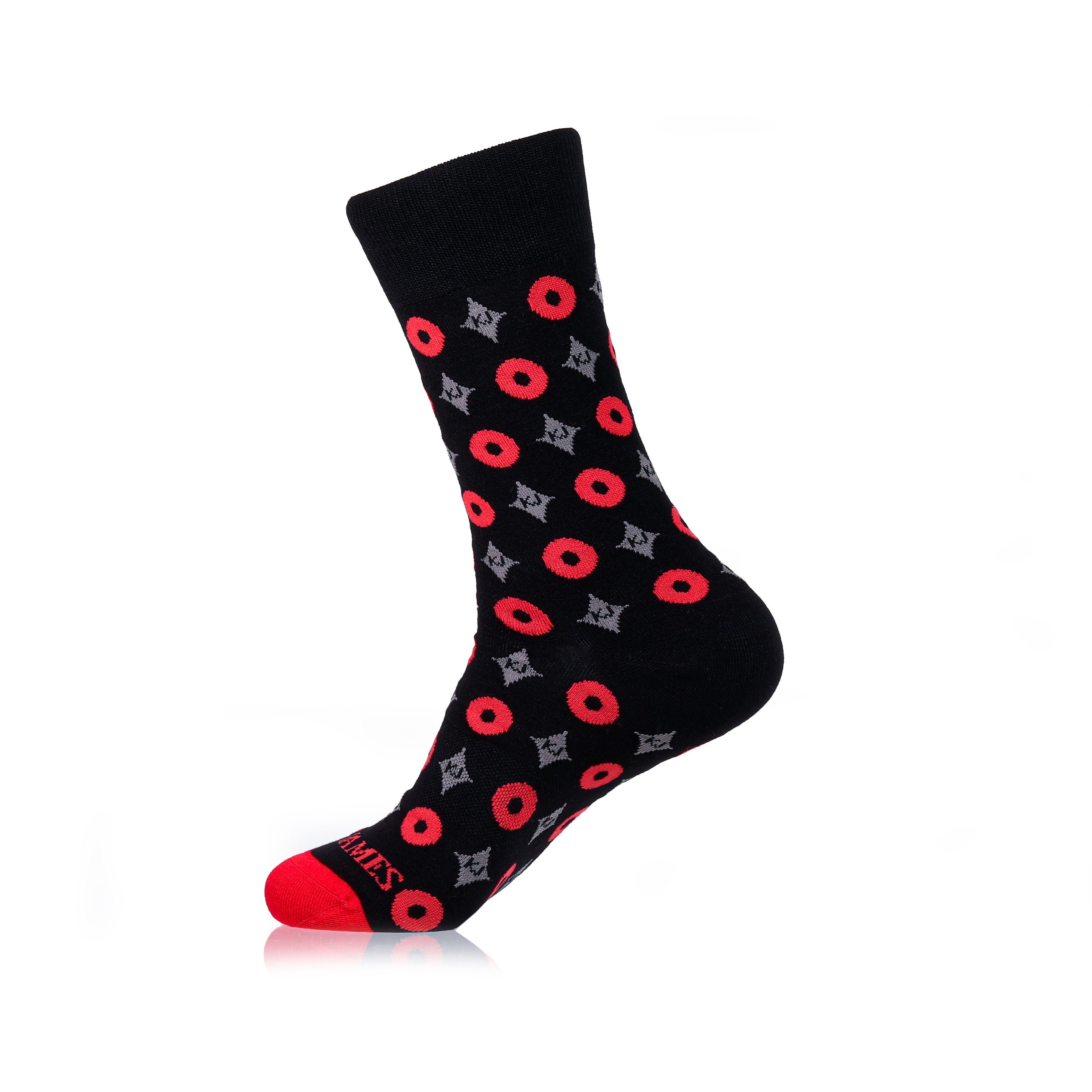 A pair of black crew socks with a geometric pattern consisting of red circles and gray accents, designed for men.