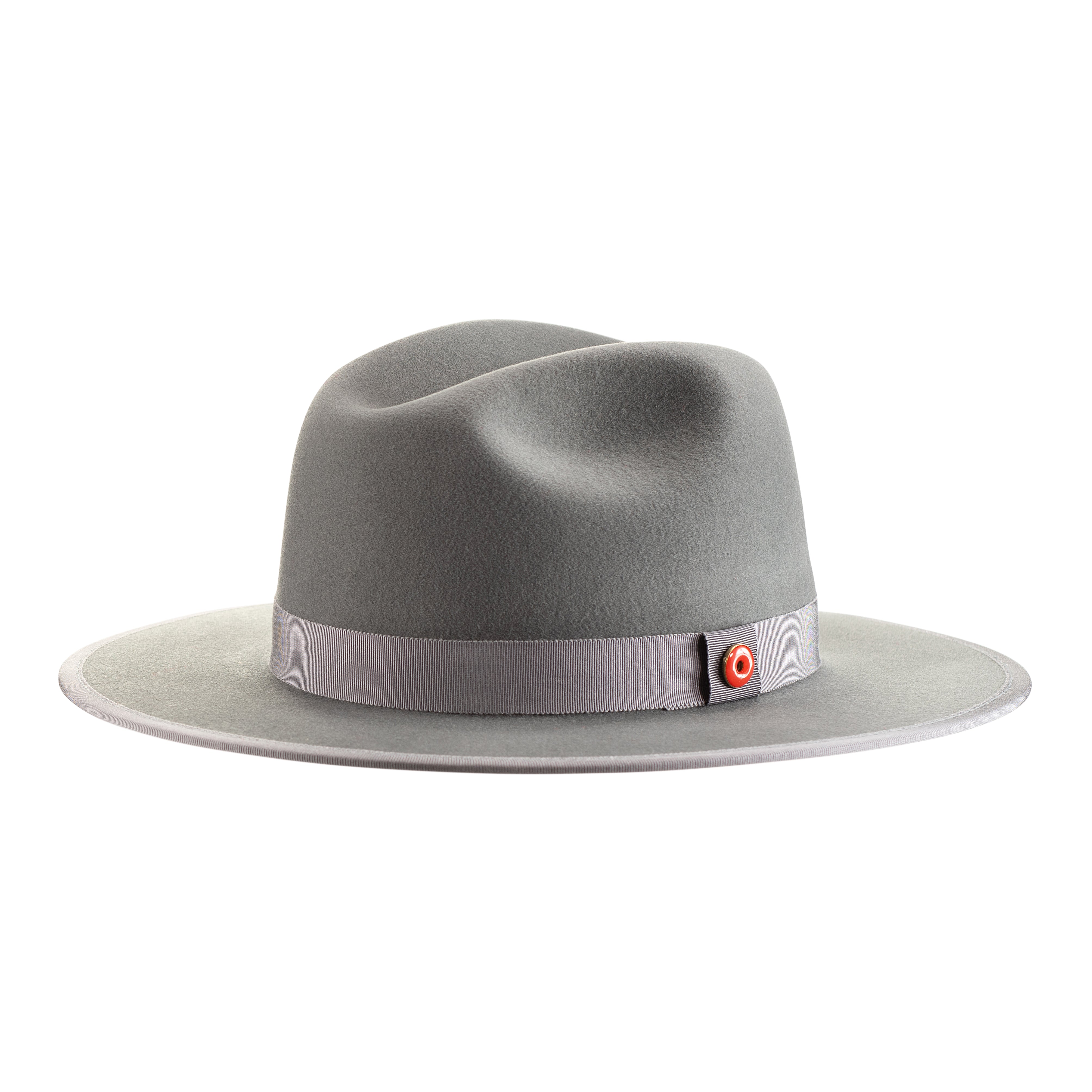 A cool grey pinched crown fedora hat with a flat brim and a classic ribbon trim, including a signature logo pin and red bottom brim.
