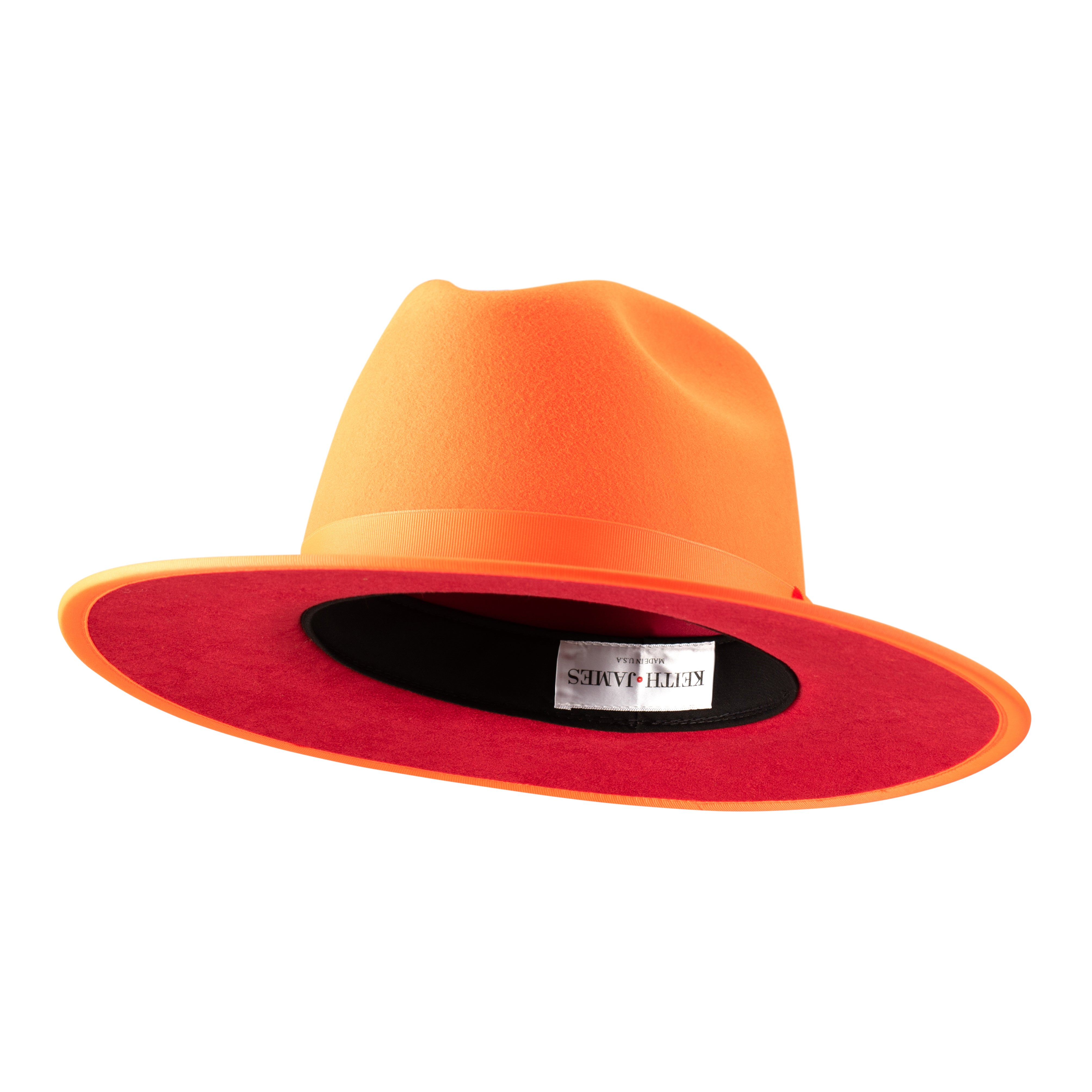 An orange fedora hat with a pinched crown and flat brim, featuring a classic ribbon trim and a signature logo pin on the front.