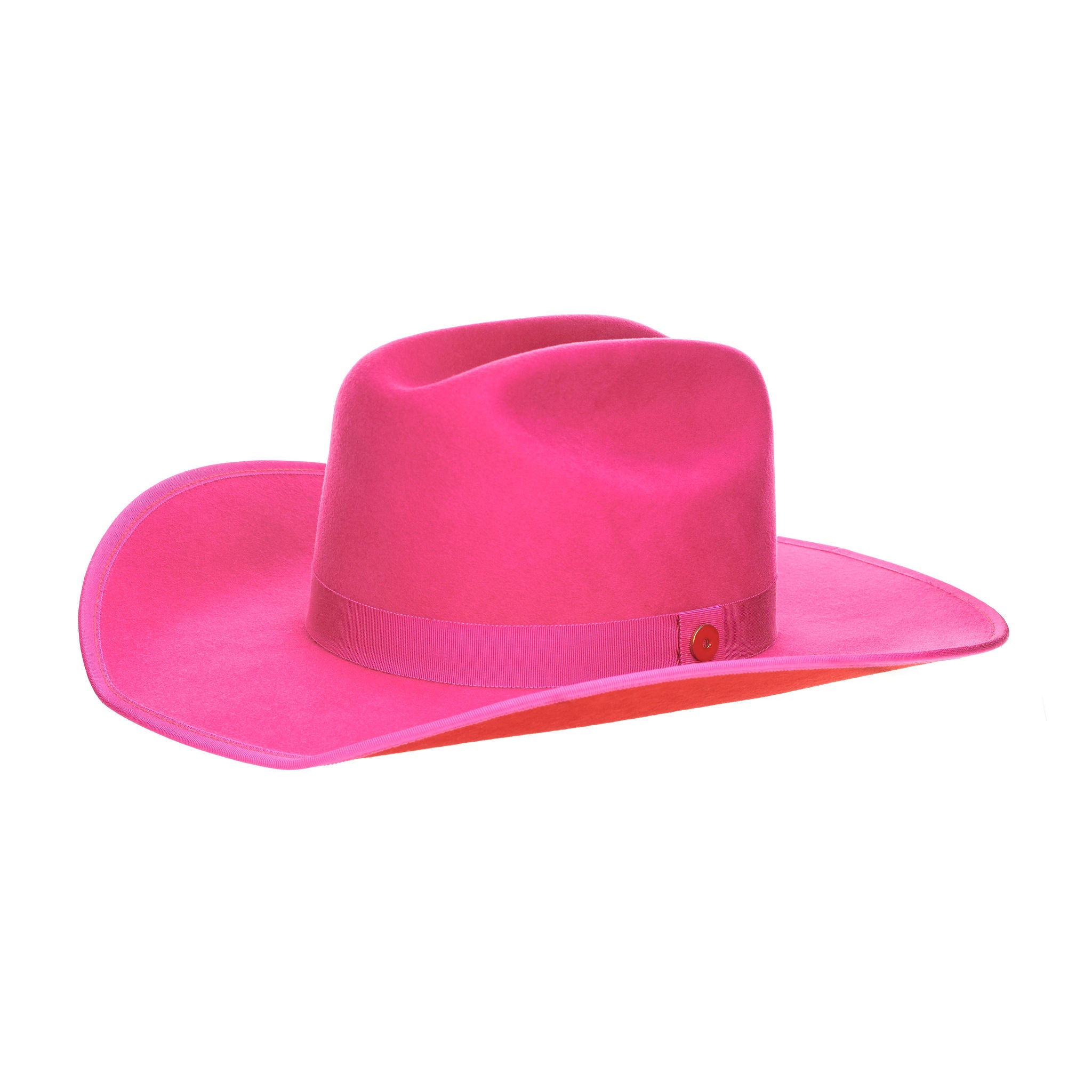 A hot pink cowboy hat with a red suede brim and a logo pin.