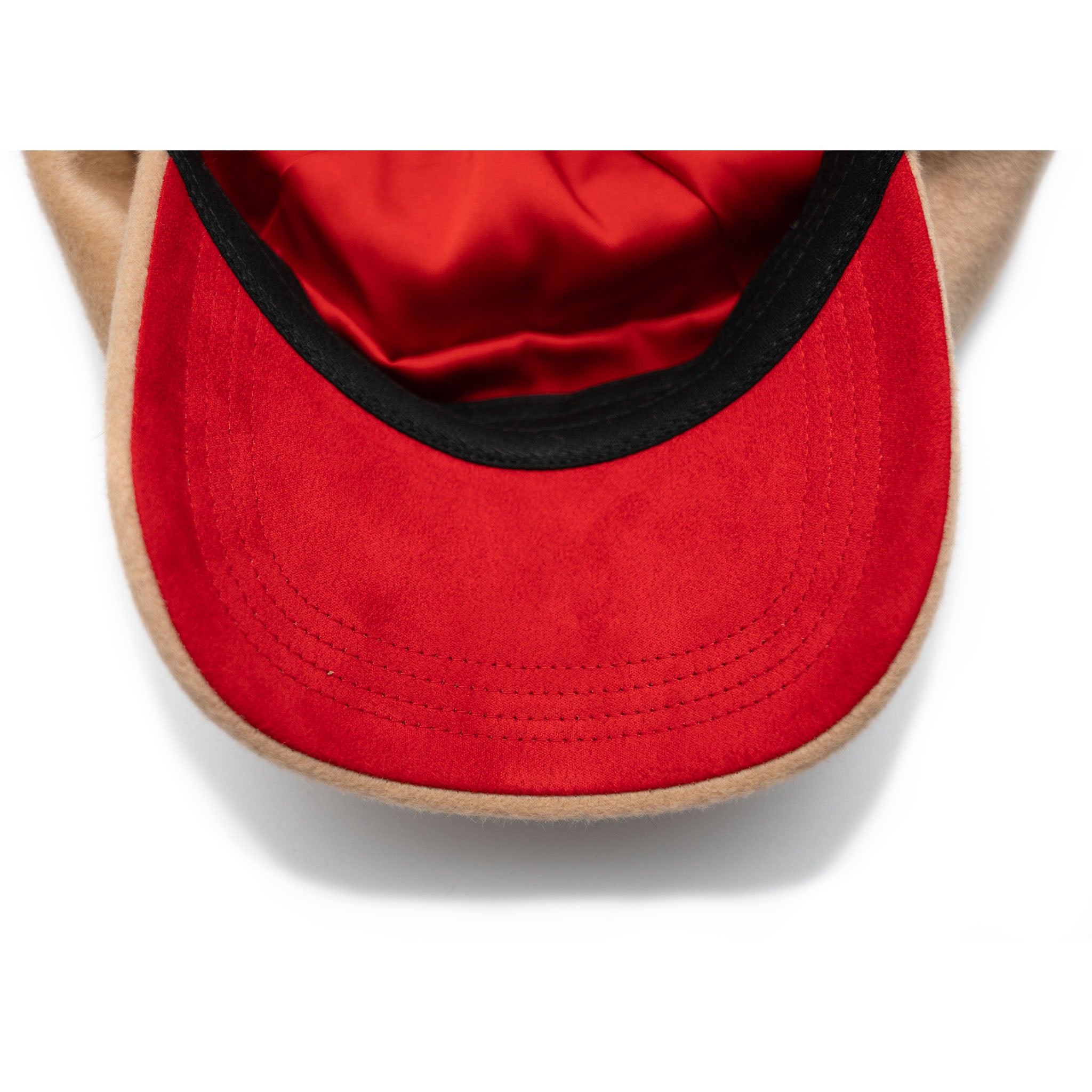 A beige colored wool hat with a cotton twill visor, featuring a satin padded sweatband and a signature logo pin.