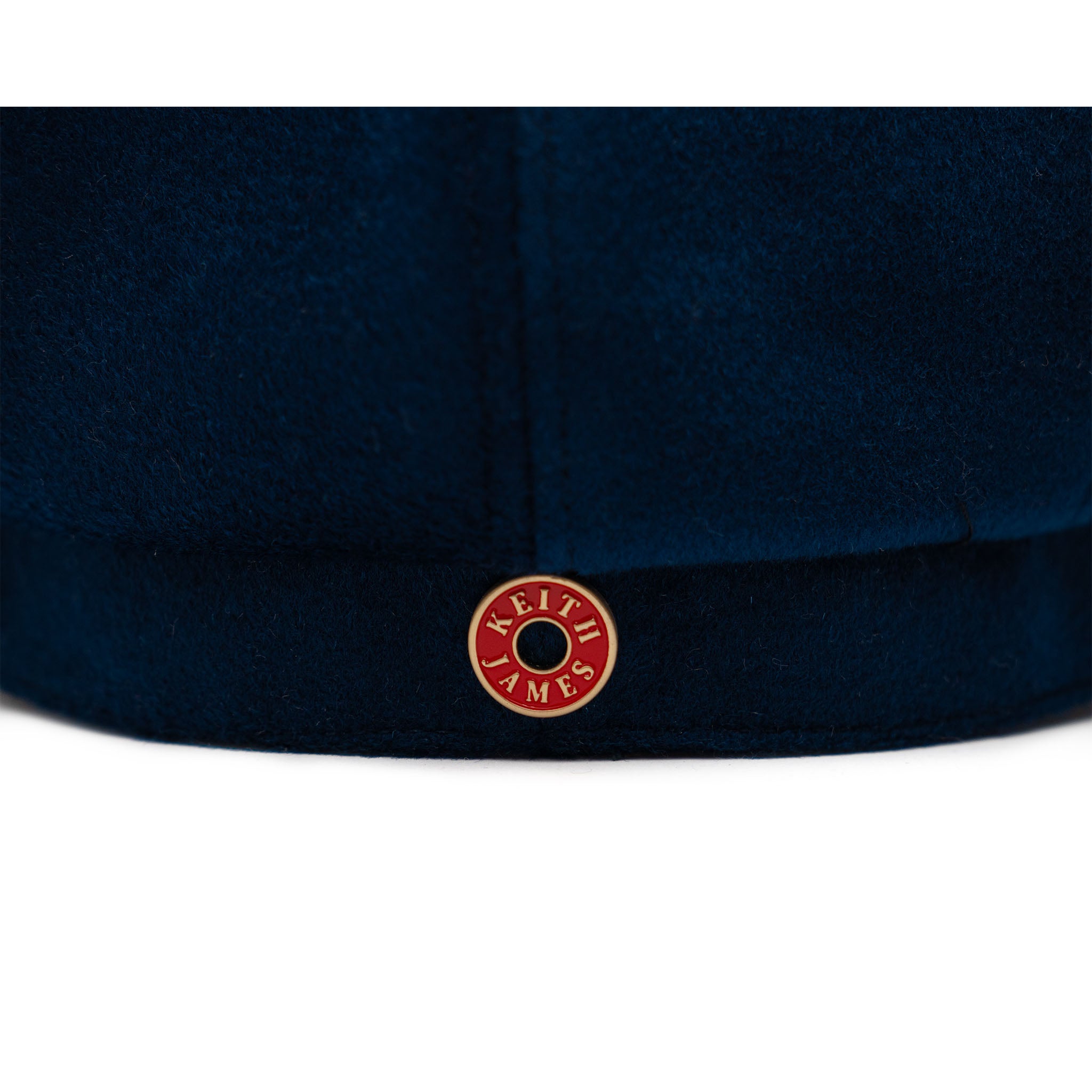 A sapphire blue colored hat made of wool with a satin lining and gold hardware.