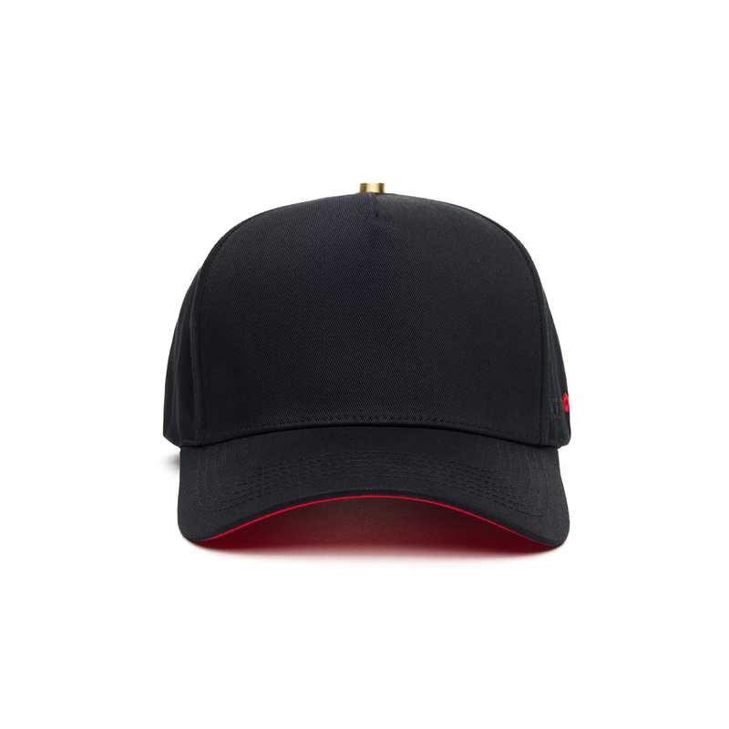 A black 5 panel baseball cap with an adjustable band and a red signature on the brim.