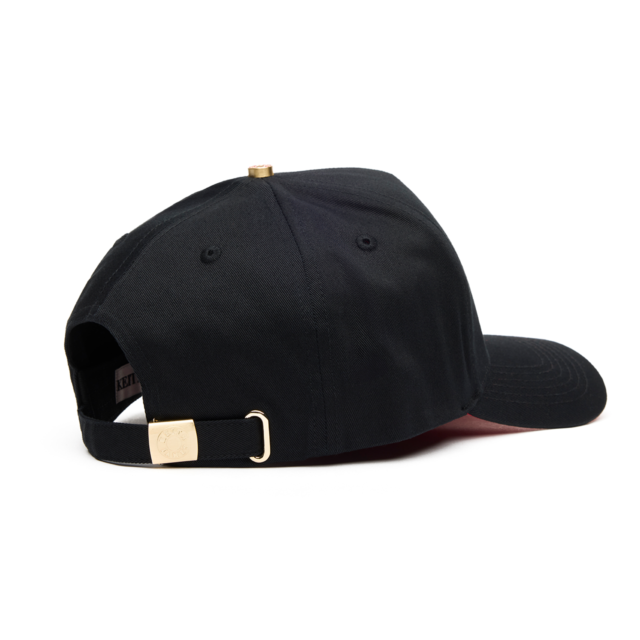 A black 5 panel baseball cap with an adjustable band and a red signature on the brim.