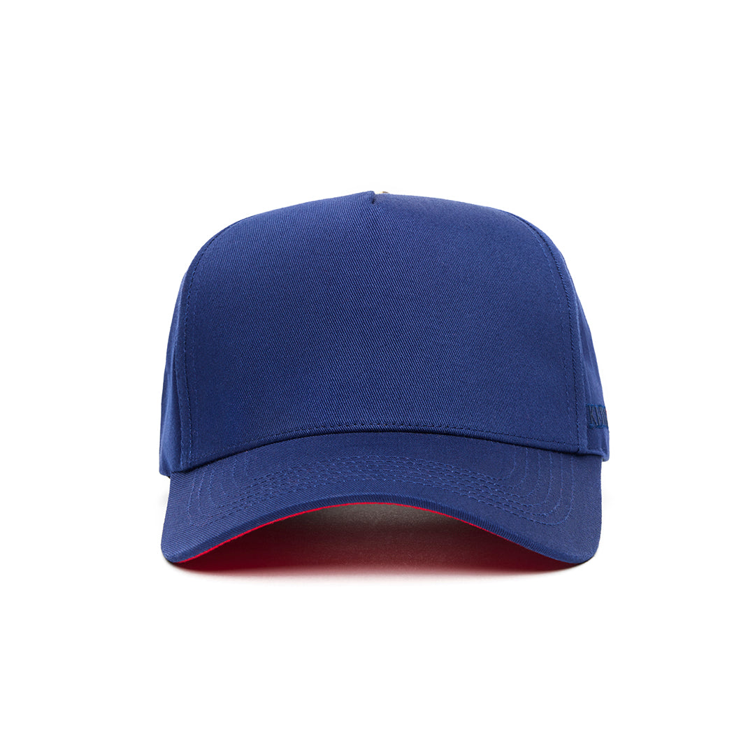 A navy blue 5 panel baseball cap with an adjustable band and a red bottom brim, featuring a logo embroidered on the front.
