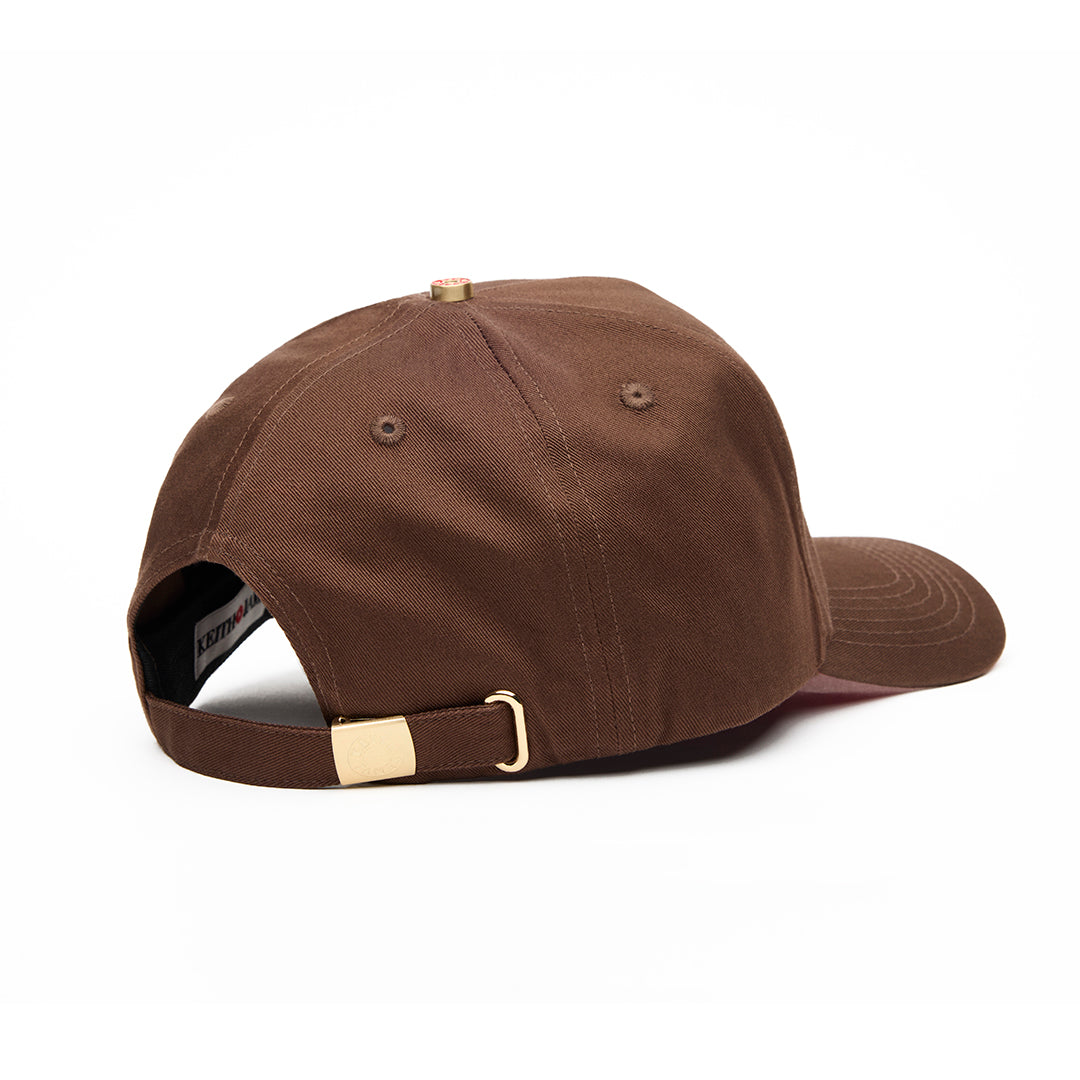 A brown 5 panel baseball cap with 'KEITH JAMES' embroidered in a circular logo on the front.