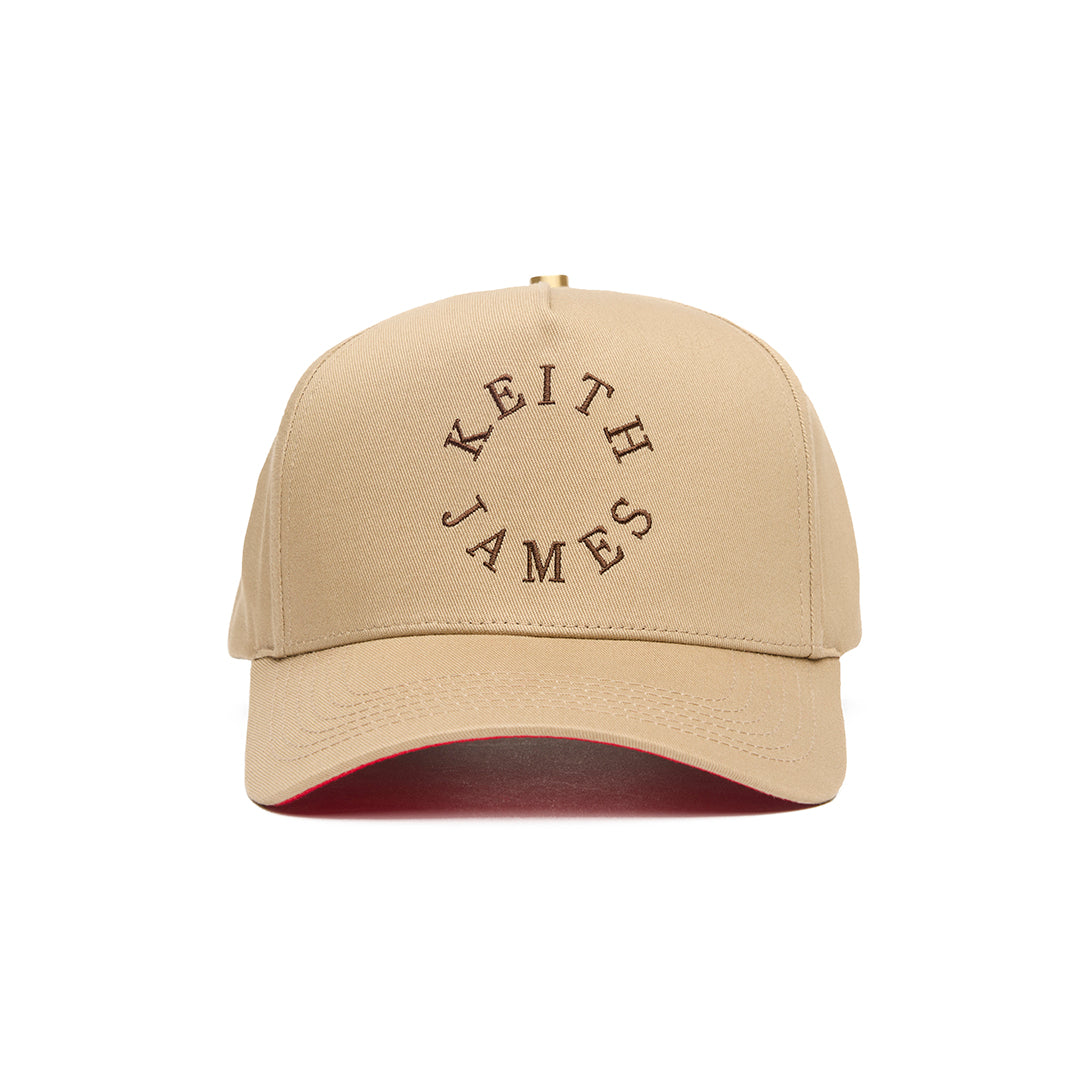 A golden honey 5 panel baseball cap with 'KEITH JAMES' embroidered in a circular logo on the front.