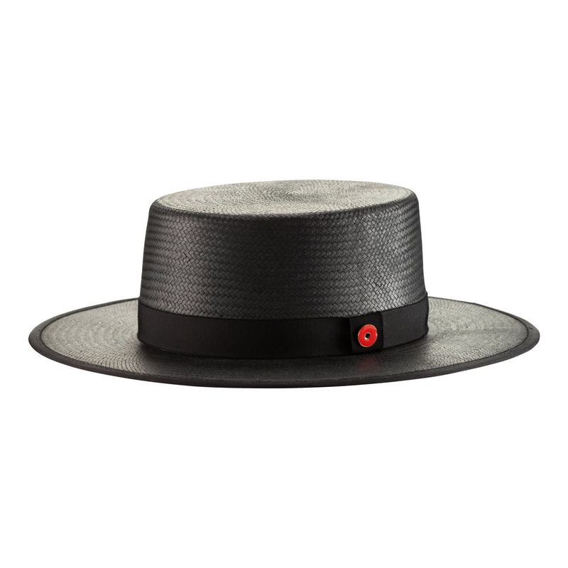 Black straw hat with a red button on a white background