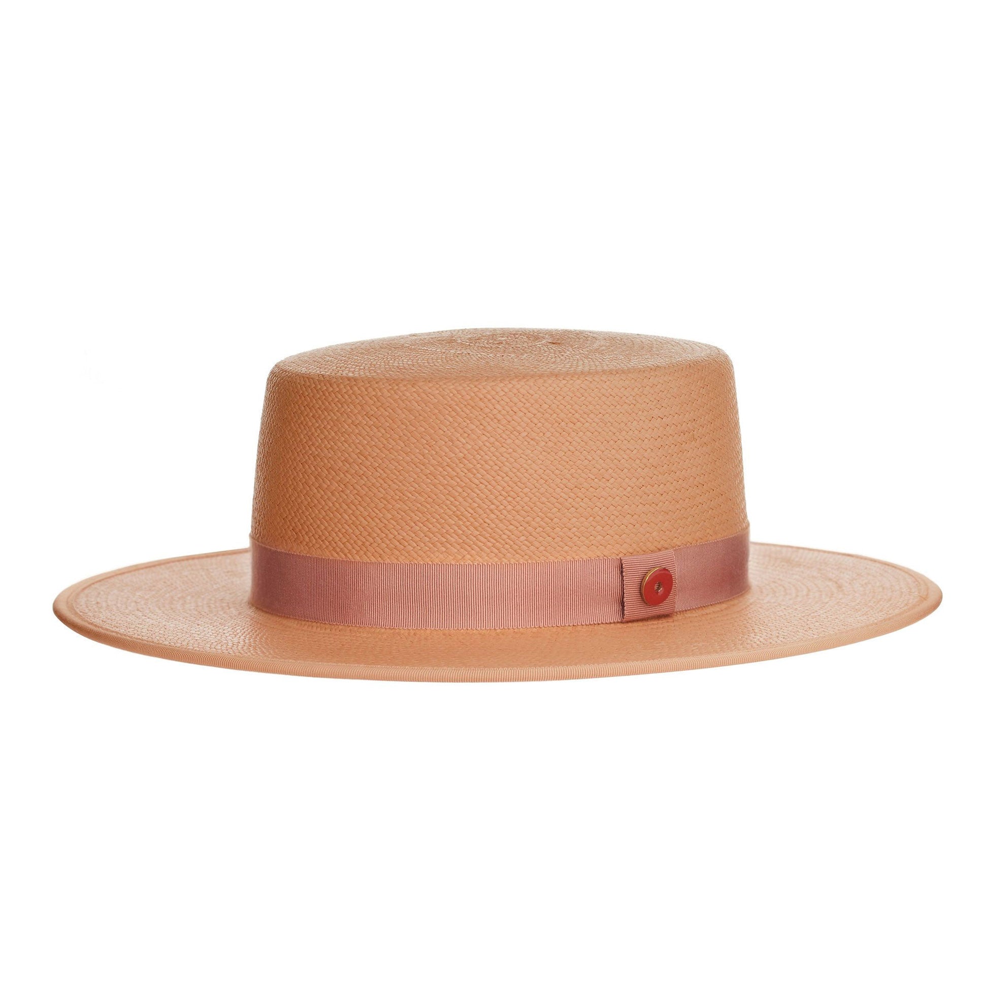 Pink straw hat with a band and button on a white background