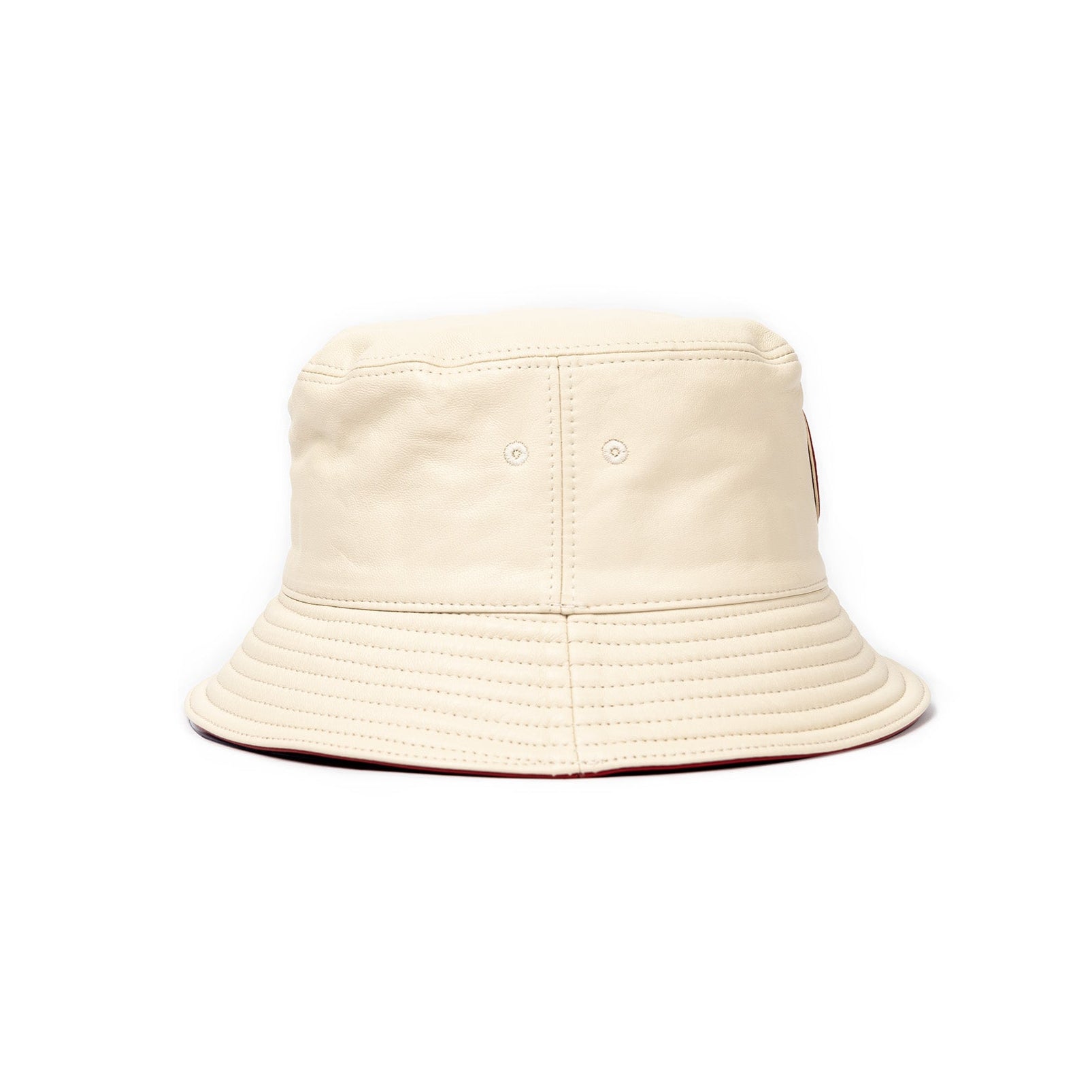 A beige leather bucket hat with a red stamped leather logo circle on the front.
