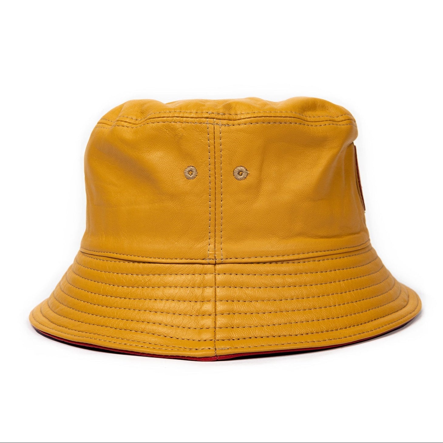 A canary yellow leather bucket hat with a stamped leather logo circle in the center.