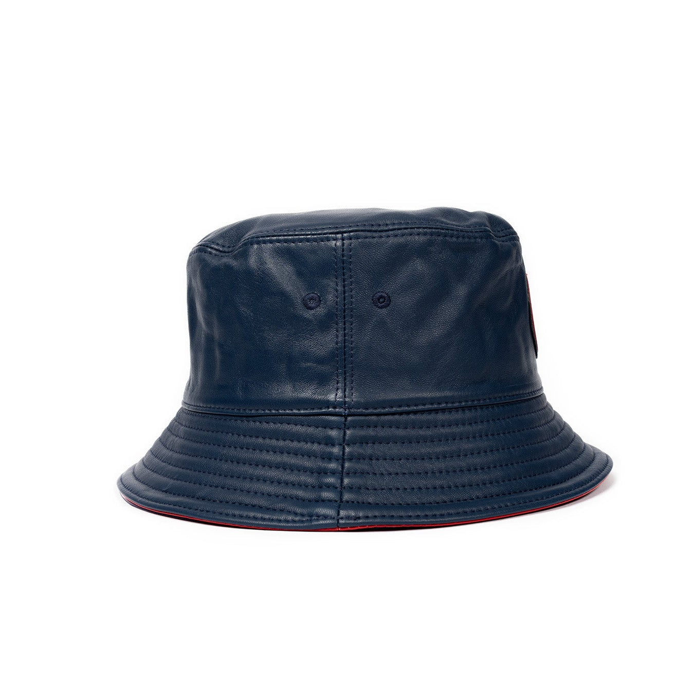 A navy blue leather bucket hat with a stamped leather logo circle on the front.