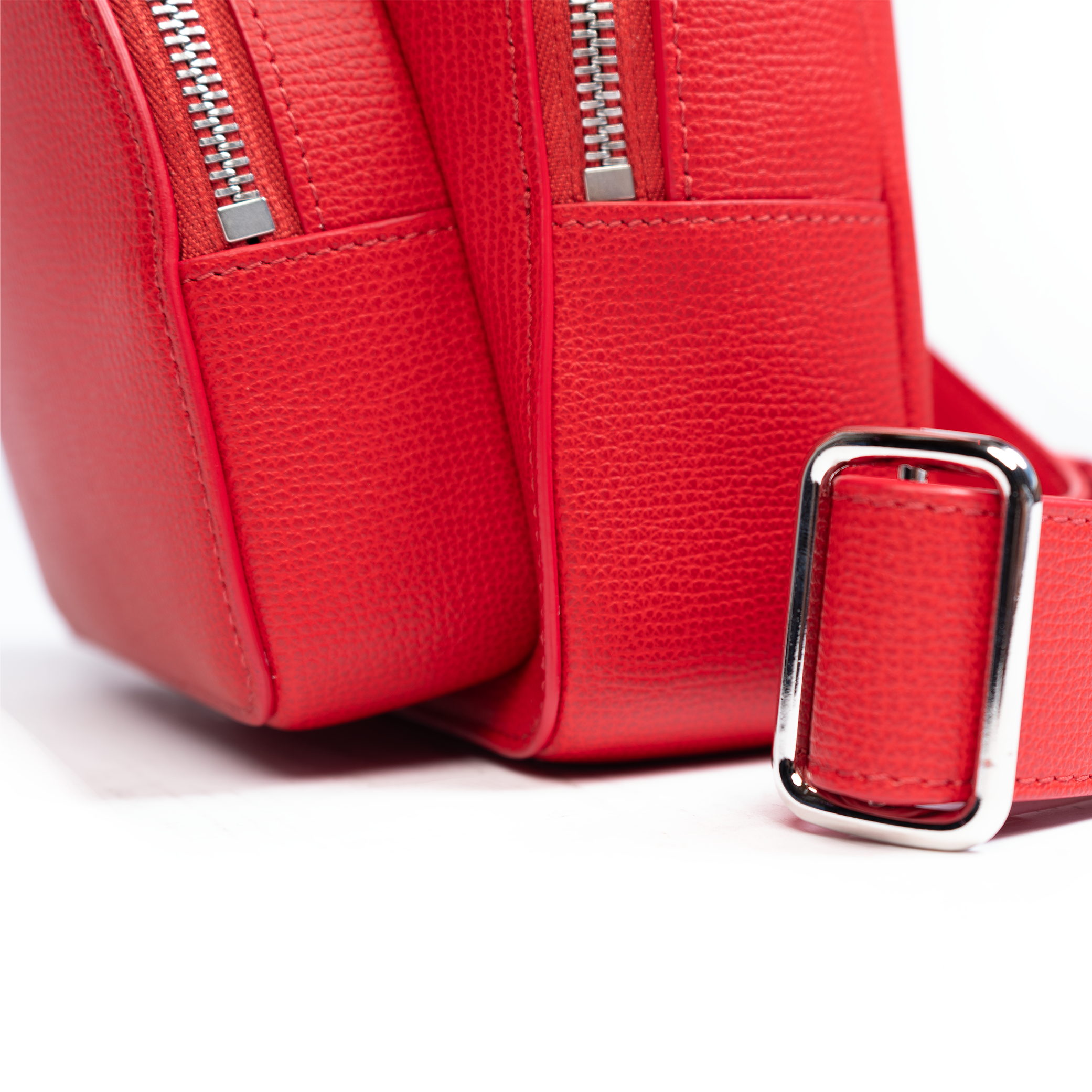 A rose red backpack with a front zipper pocket and adjustable straps on a white background.