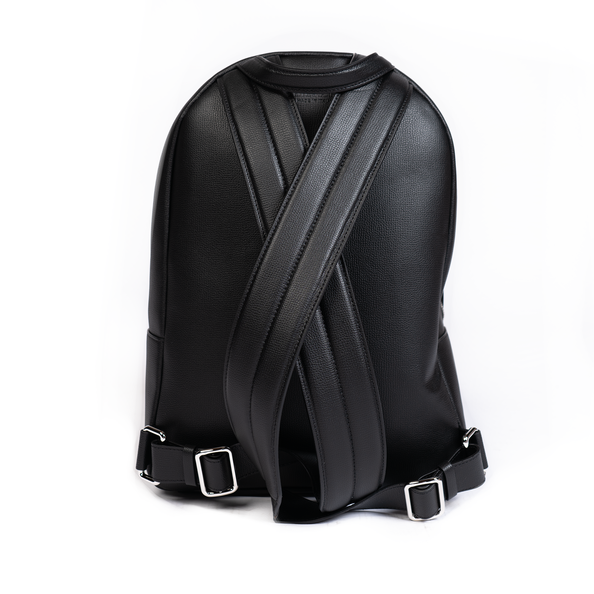 A jet black leather backpack with gold-tone hardware, featuring multiple compartments and a front zipper pocket.