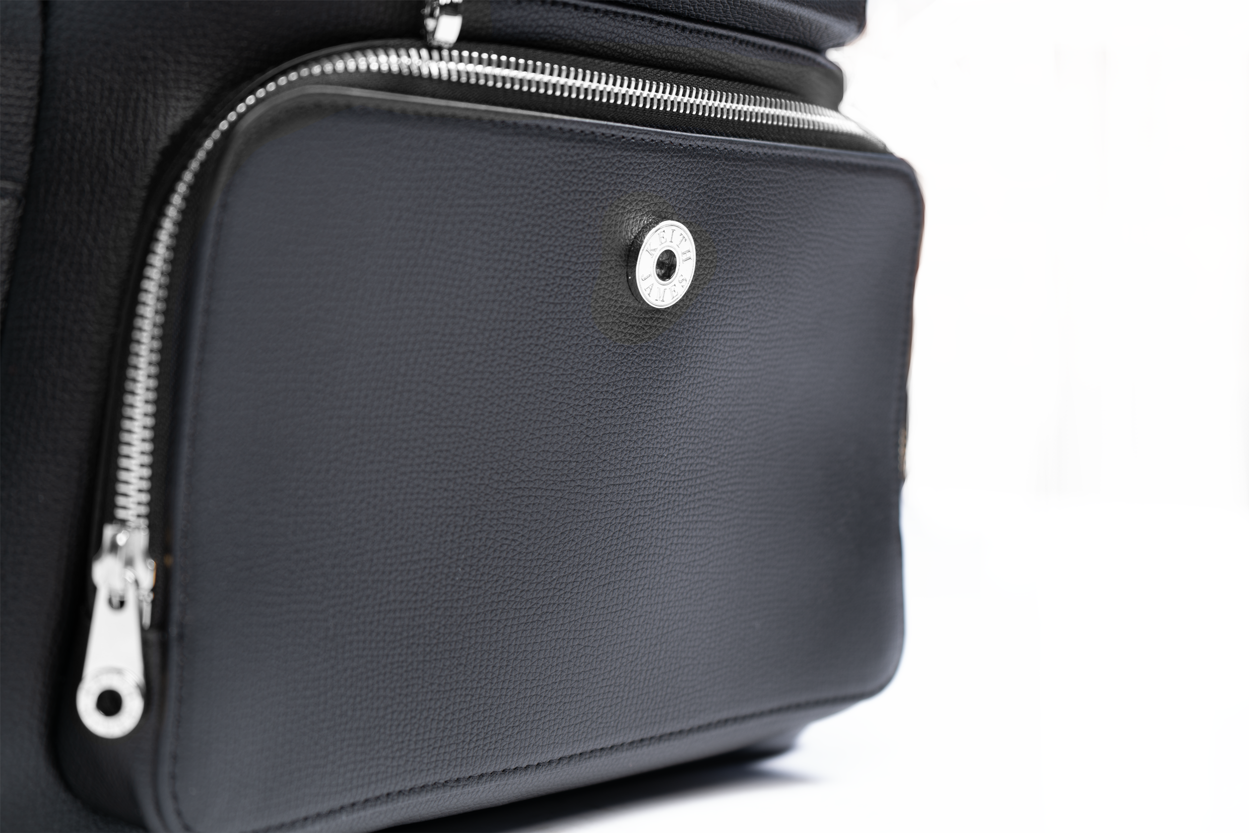 A jet black leather backpack with gold-tone hardware, featuring multiple compartments and a front zipper pocket.