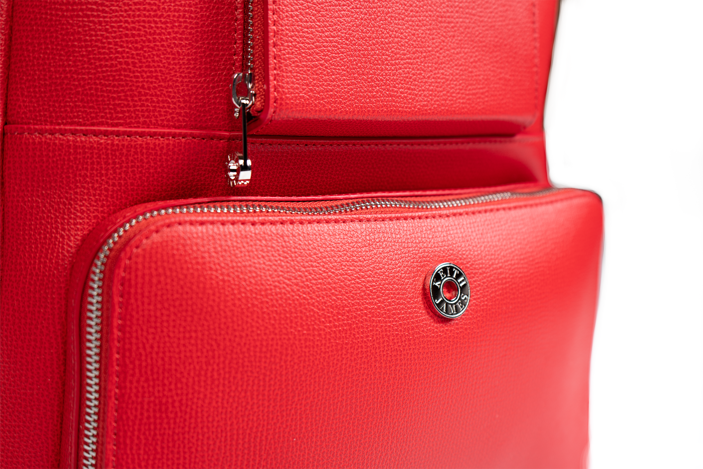 A rose red leather backpack with a front pocket and visible brand logo.