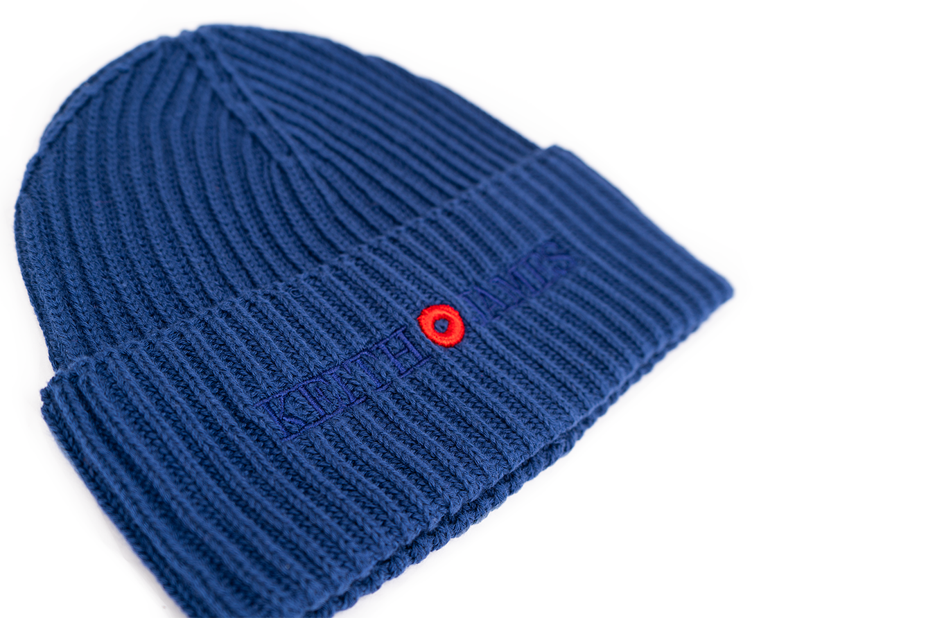 A blue rib-knit beanie with an embroidered logo on the front.