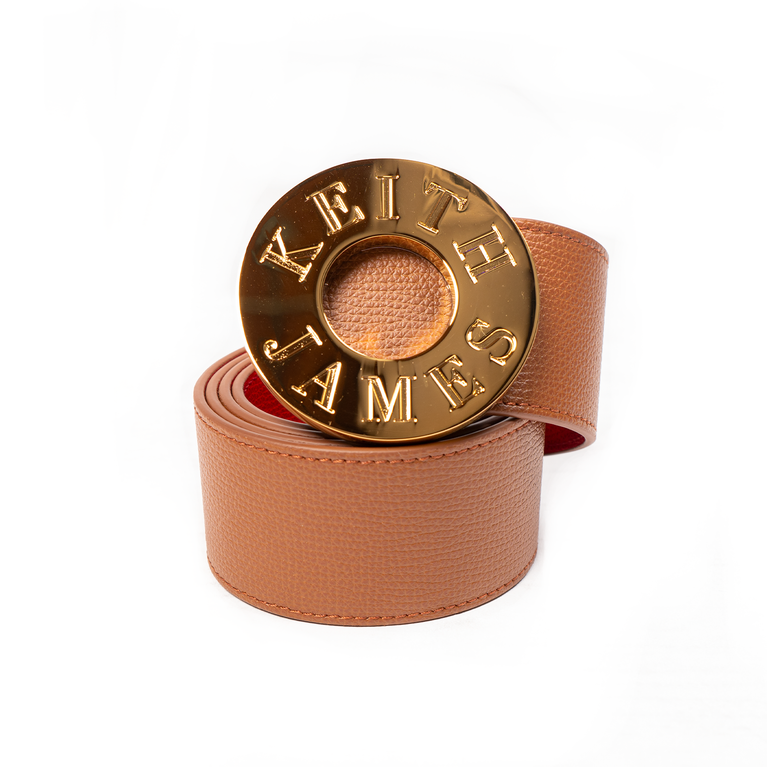 A shiny gold buckle with the inscription 'KING' on a leather strap, displayed against a white background.