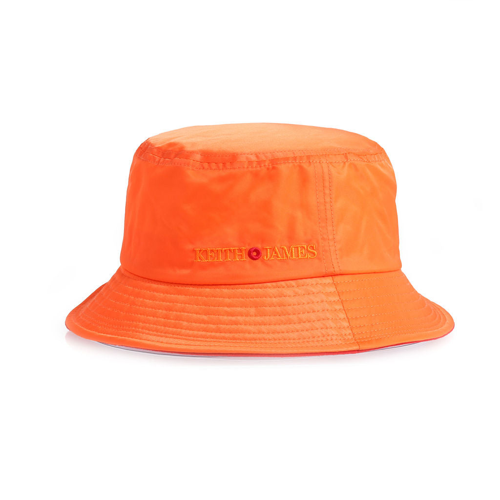 A citrus orange bucket hat with the text 'KEITH JAMES' embroidered on the front.