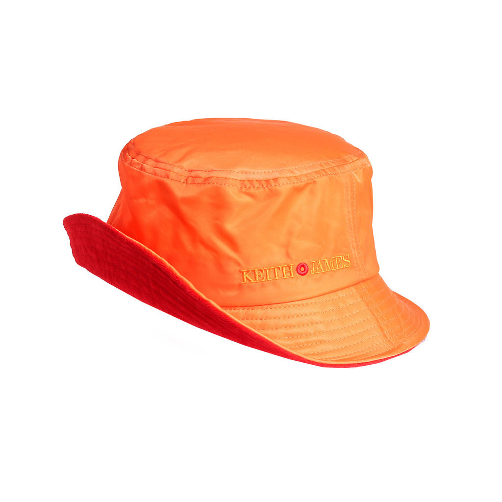 A citrus orange bucket hat with the text 'KEITH JAMES' embroidered on the front.