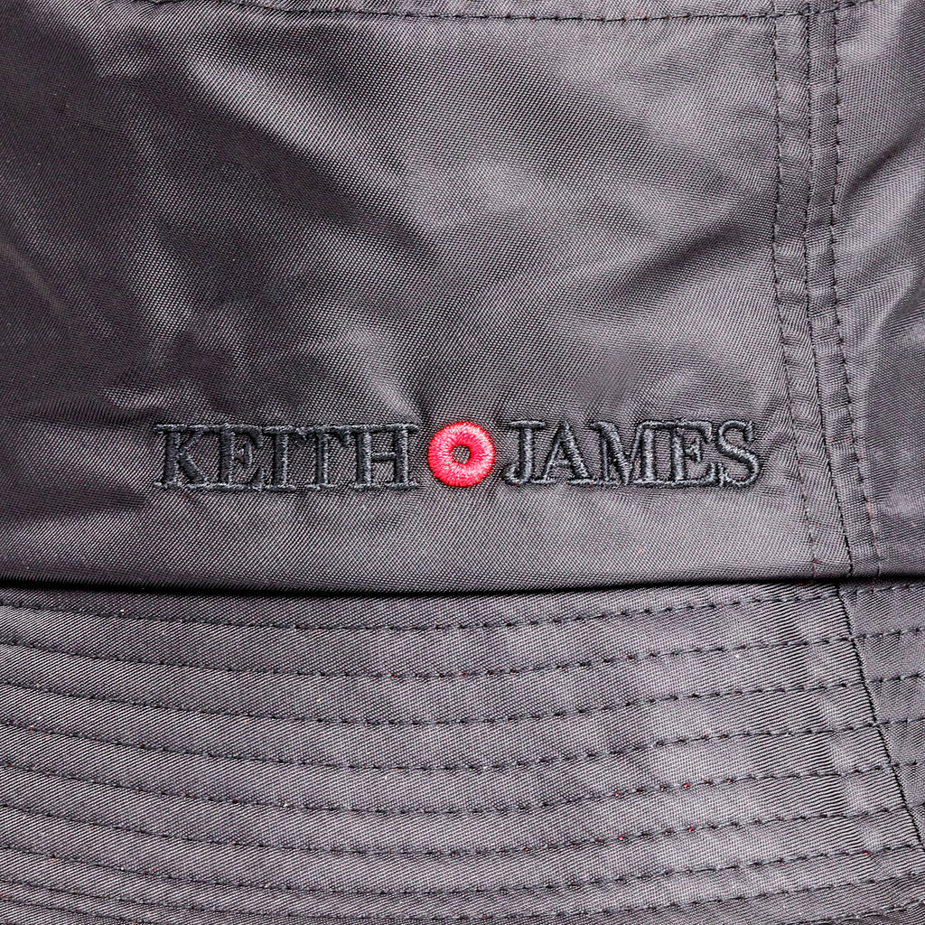 A jet black bucket hat with a red detail around the base.