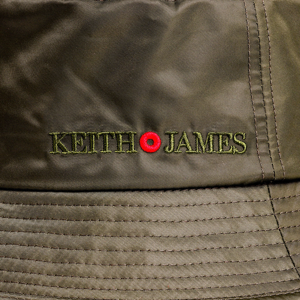 Olive green bucket hat with a red trim and the brand name 'Keith James' embroidered on the front.