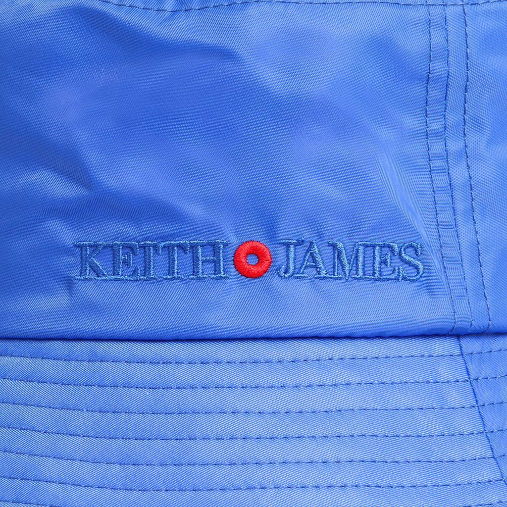 A true blue bucket hat with a red trim and the brand 'Keith James' embroidered on the front.
