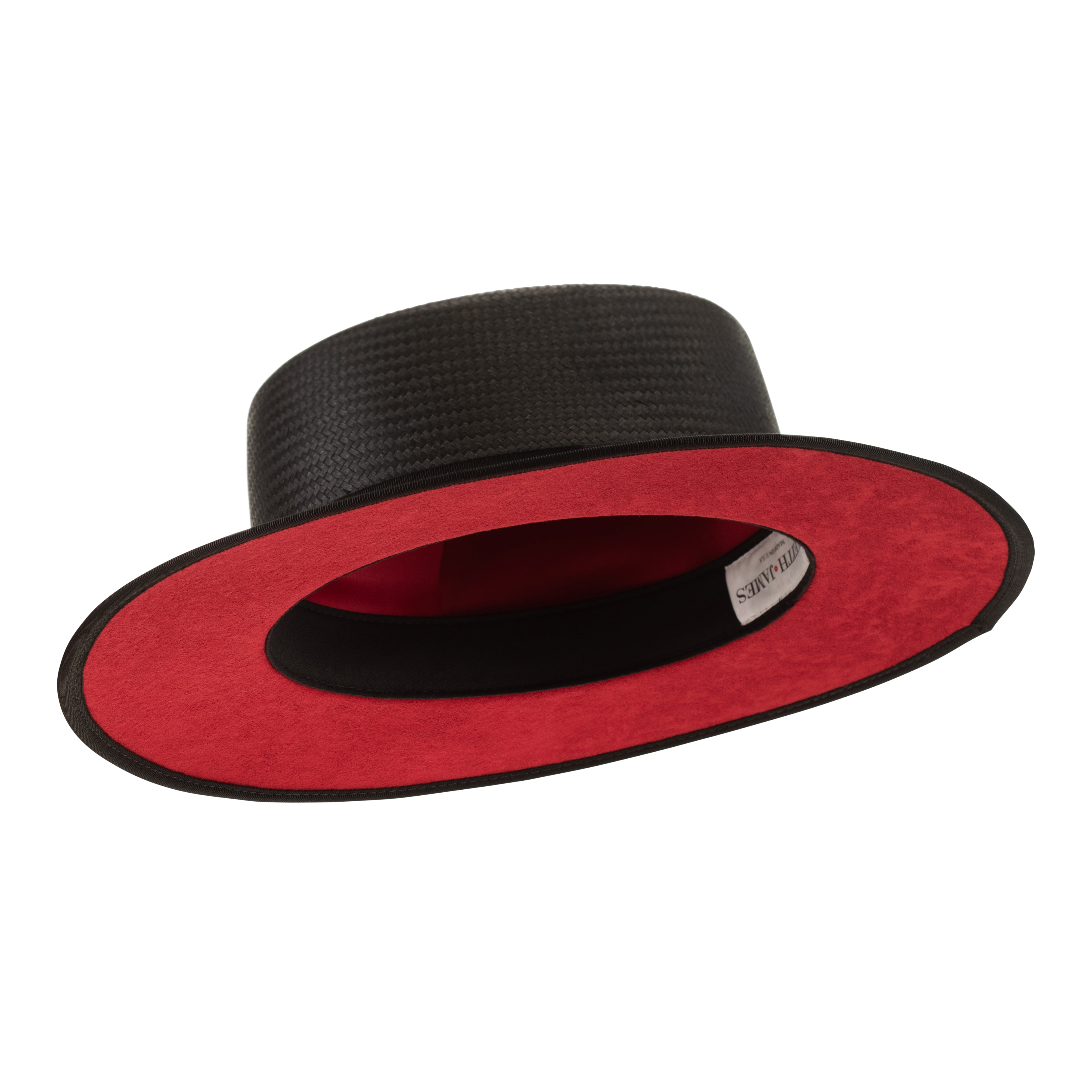 Black straw hat with a red button on a white background